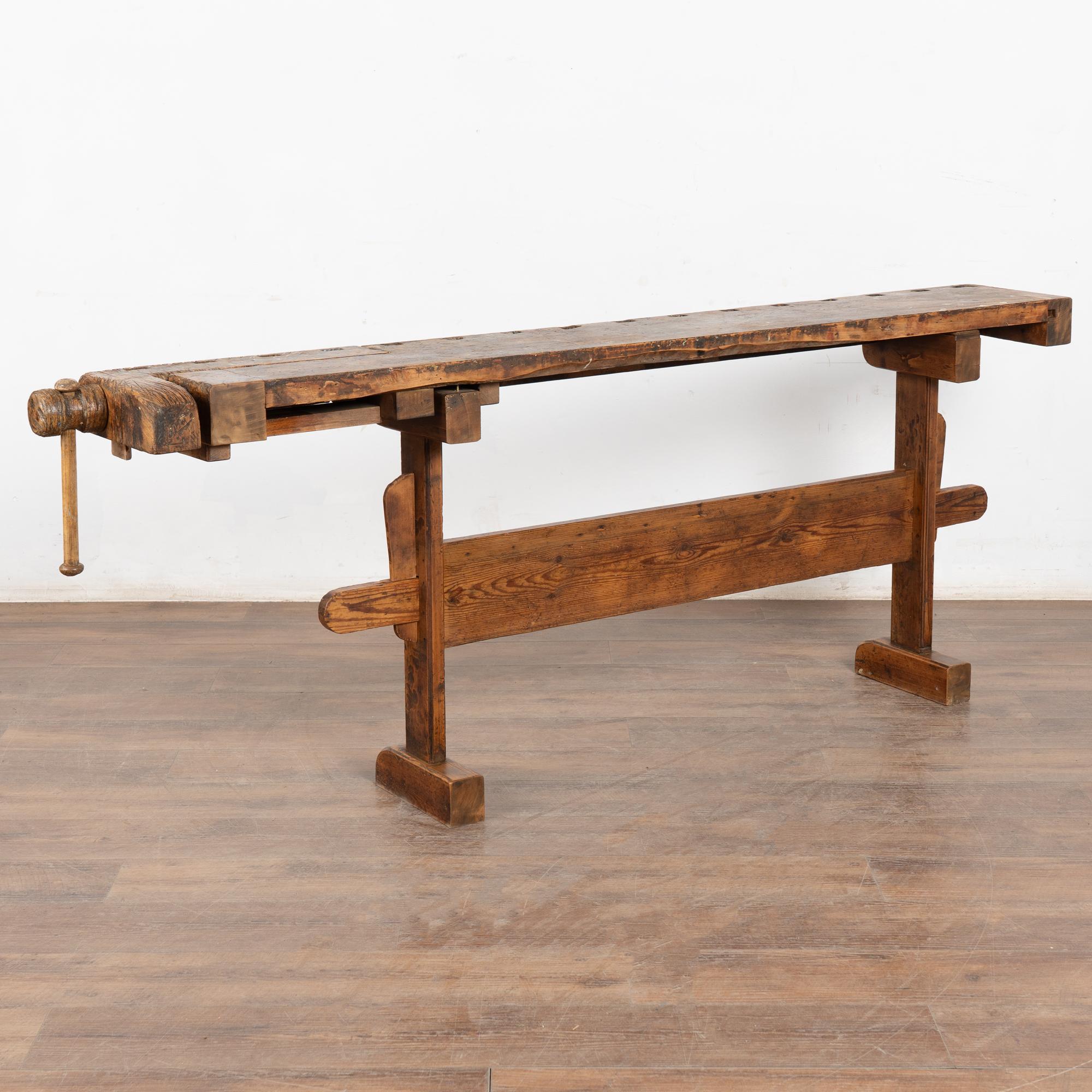 The worn patina of this old carpenter's workbench is a reflection of its age and years of use. Every ding, scratch, deep gouge, paint spill and stain enrich its character and appeal. Please examine the close up photos to appreciate the patina,