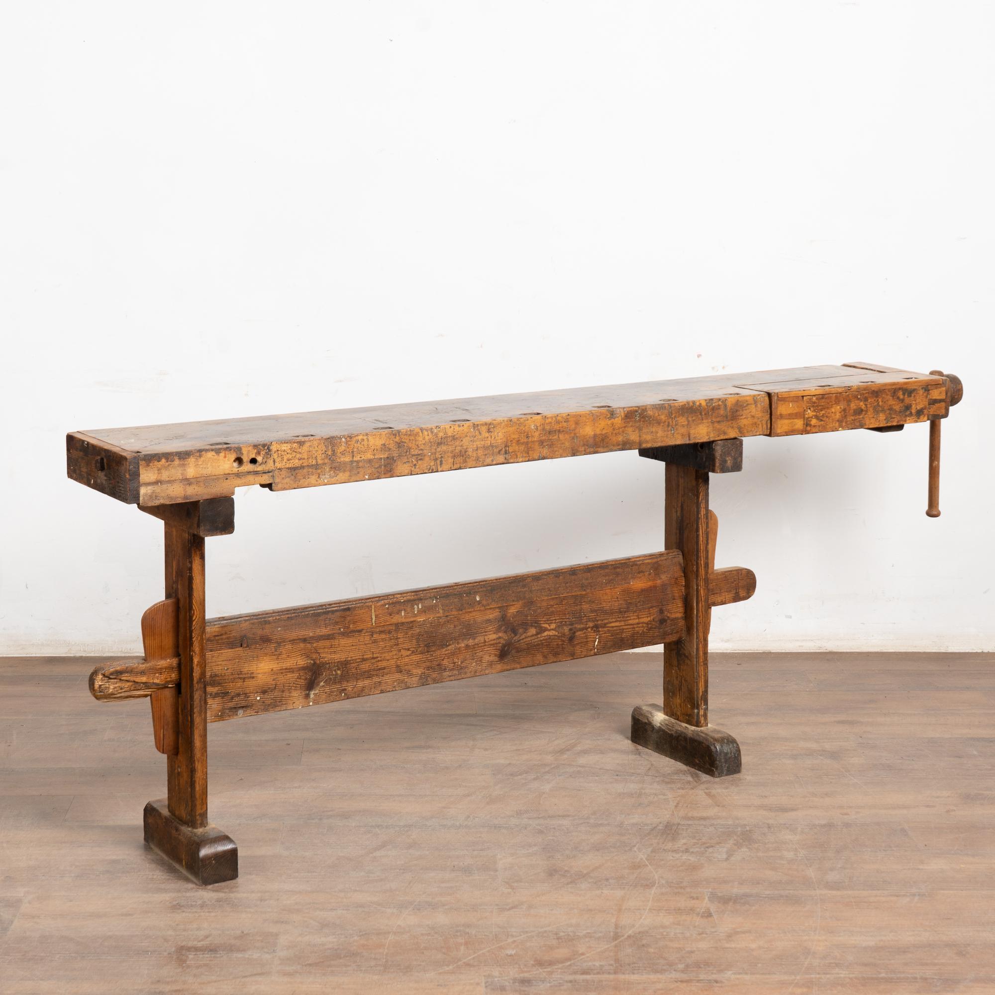 The worn patina of this old carpenter's workbench is a reflection of its age and years of use. Every ding, scratch, deep gouge, paint spill and stain enrich its character and appeal. Please examine the close up photos to appreciate the patina,