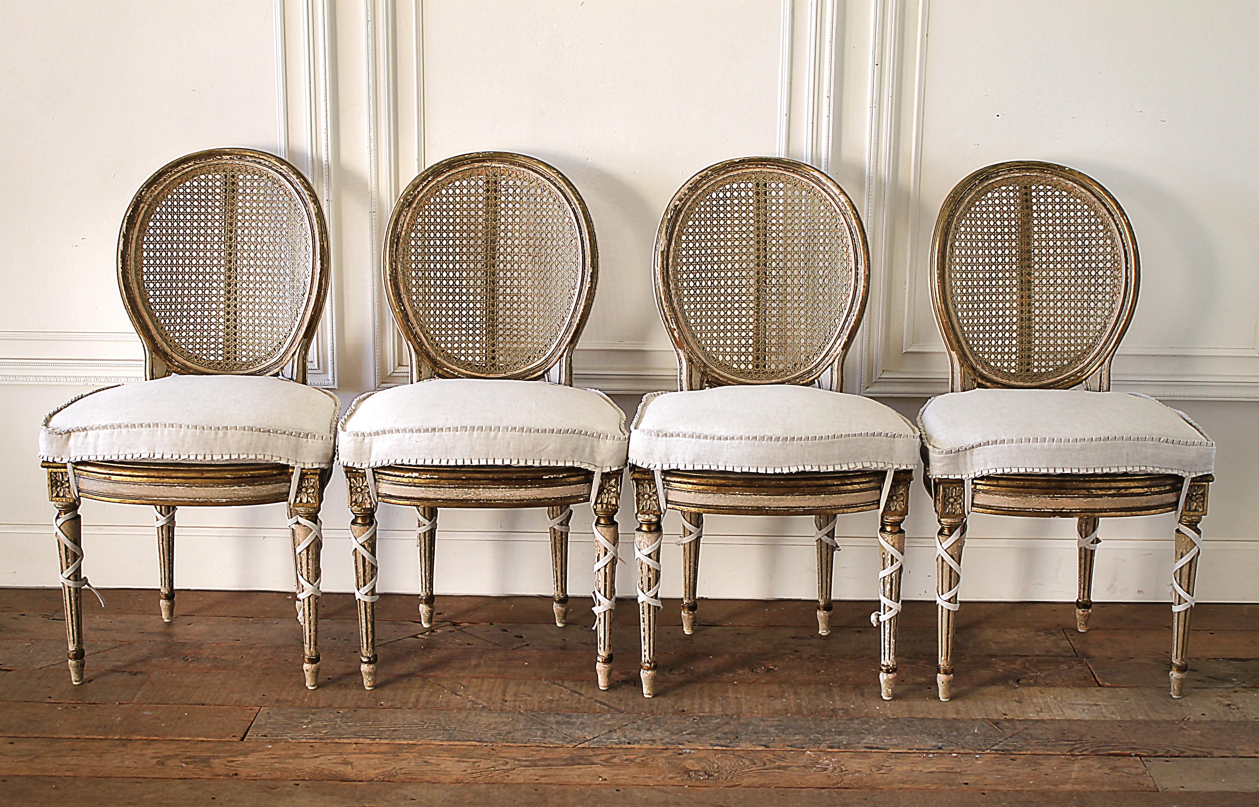 Early 20th century carved and painted Louis XVI style cane back dining chairs
Beautiful painted and gilt trimmed dining chairs with naturally aged patina, perfectly chippy in all the right places. We have sealed the finish to keep the chairs from