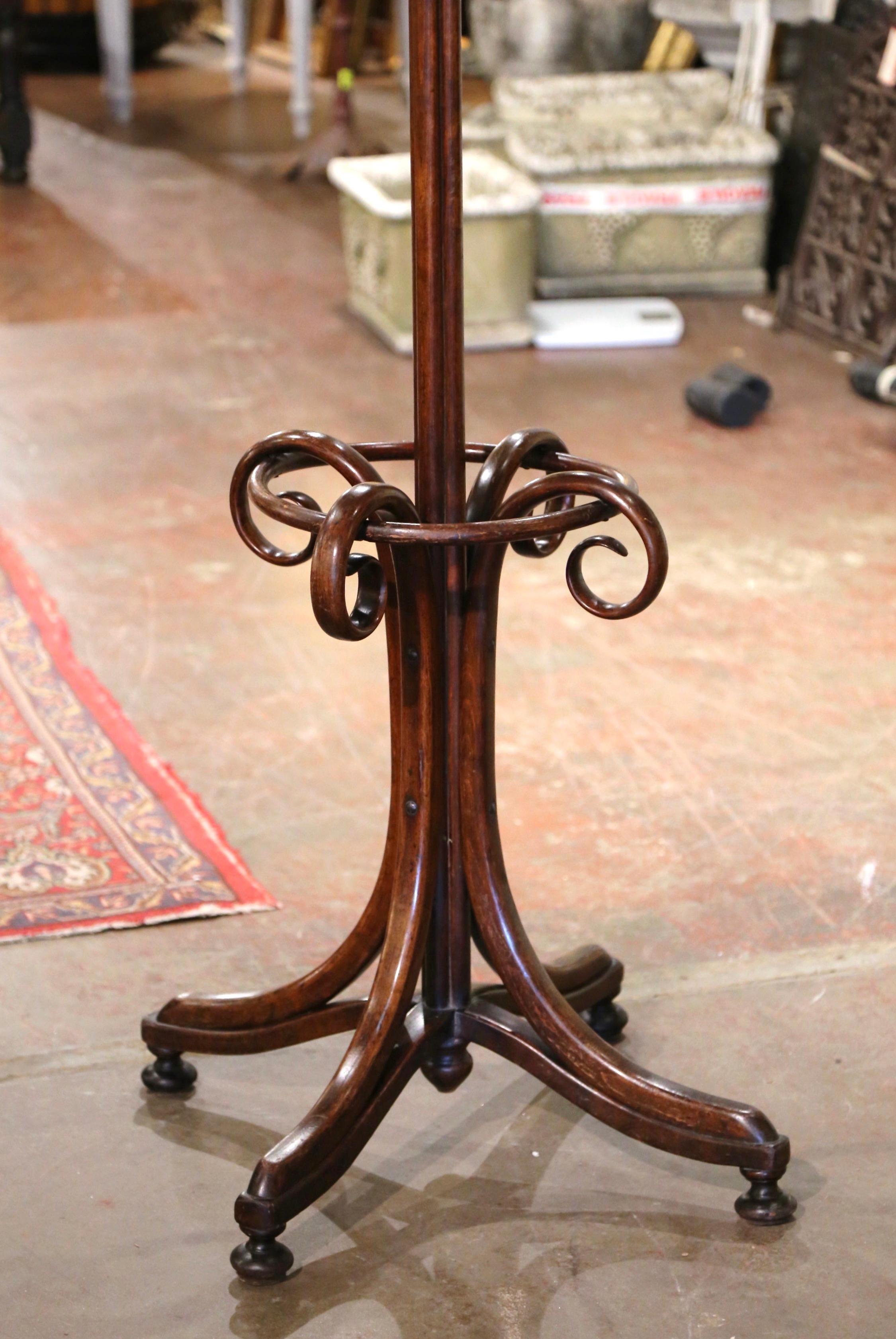 Bring a retro, yet practical touch to any entry or dressing area with this elegant, carved coat stand. Crafted in France, circa 1920 in the style of German-Austrian cabinet maker, Michael Thonet (1796-1871), the hall tree stands on four double
