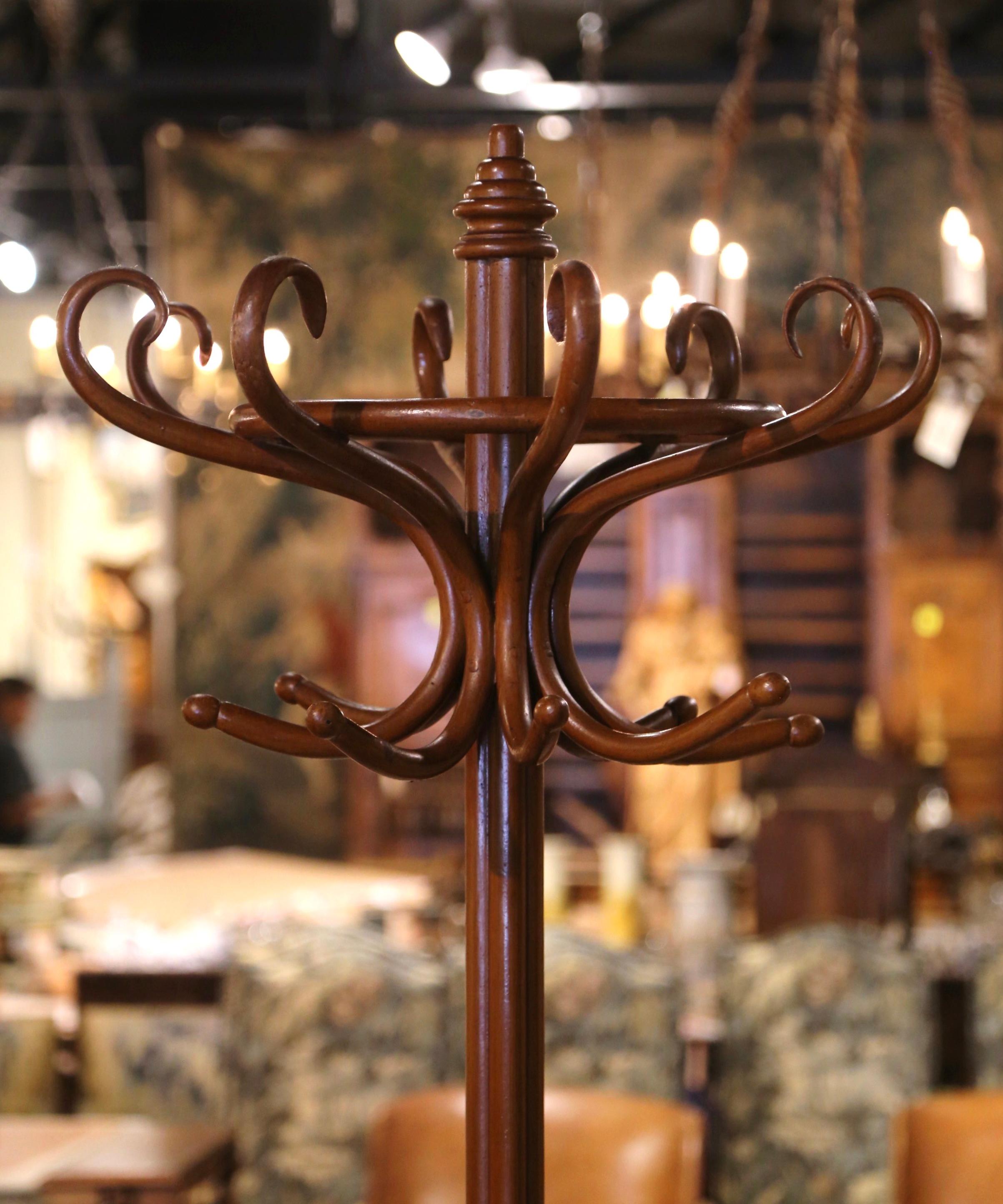 Bring a retro, yet practical touch to any entry or dressing area with this elegant, carved coat stand. The useful hat rack was crafted in France, circa 1920 in the style of German-Austrian cabinet maker, Michael Thonet (1796-1871). The hall tree