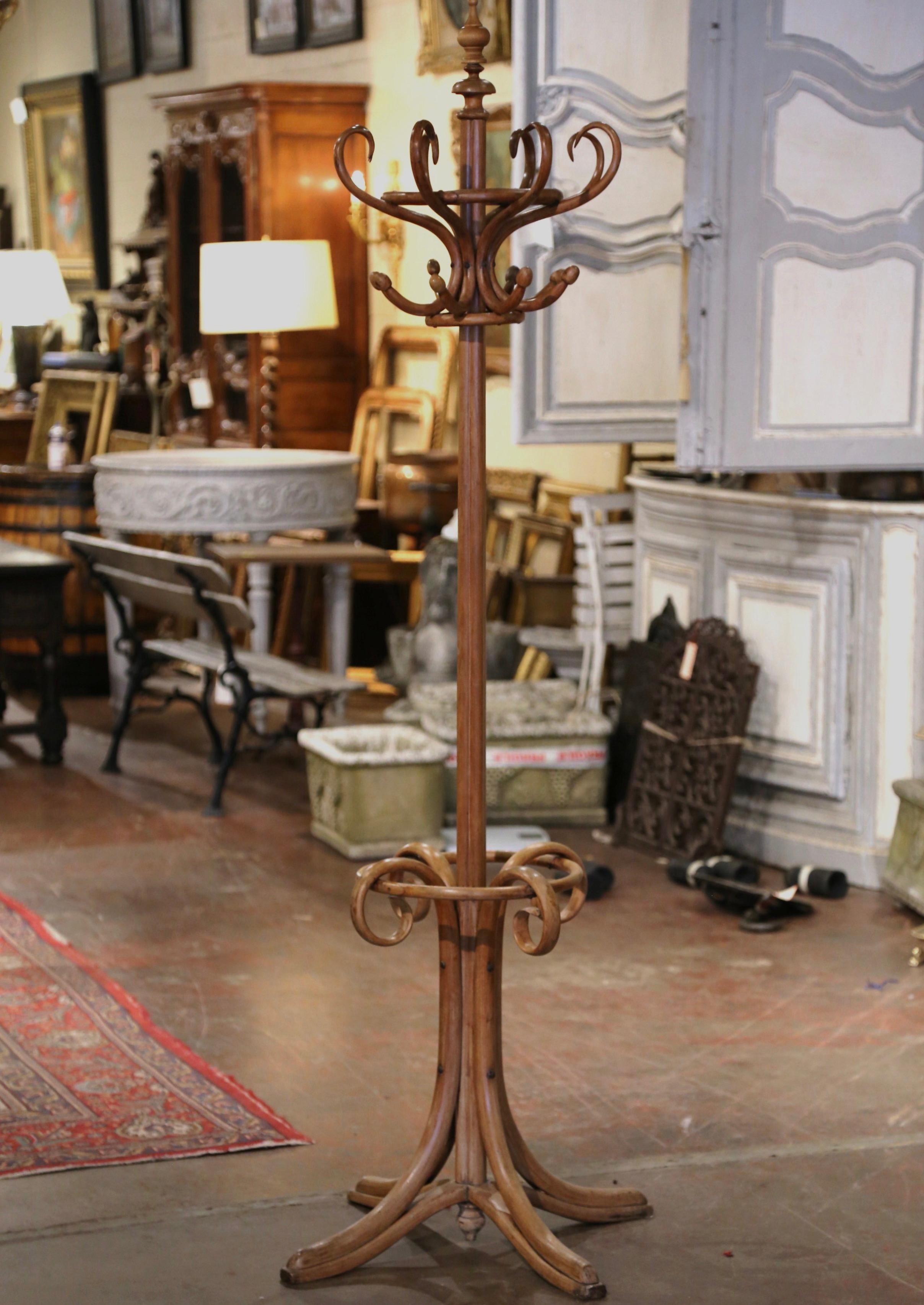 Bring a retro, yet practical touch to any entry or dressing area with this elegant, carved coat stand. The useful hat rack was crafted in France, circa 1920 in the style of German-Austrian cabinet maker, Michael Thonet (1796-1871). The hall tree