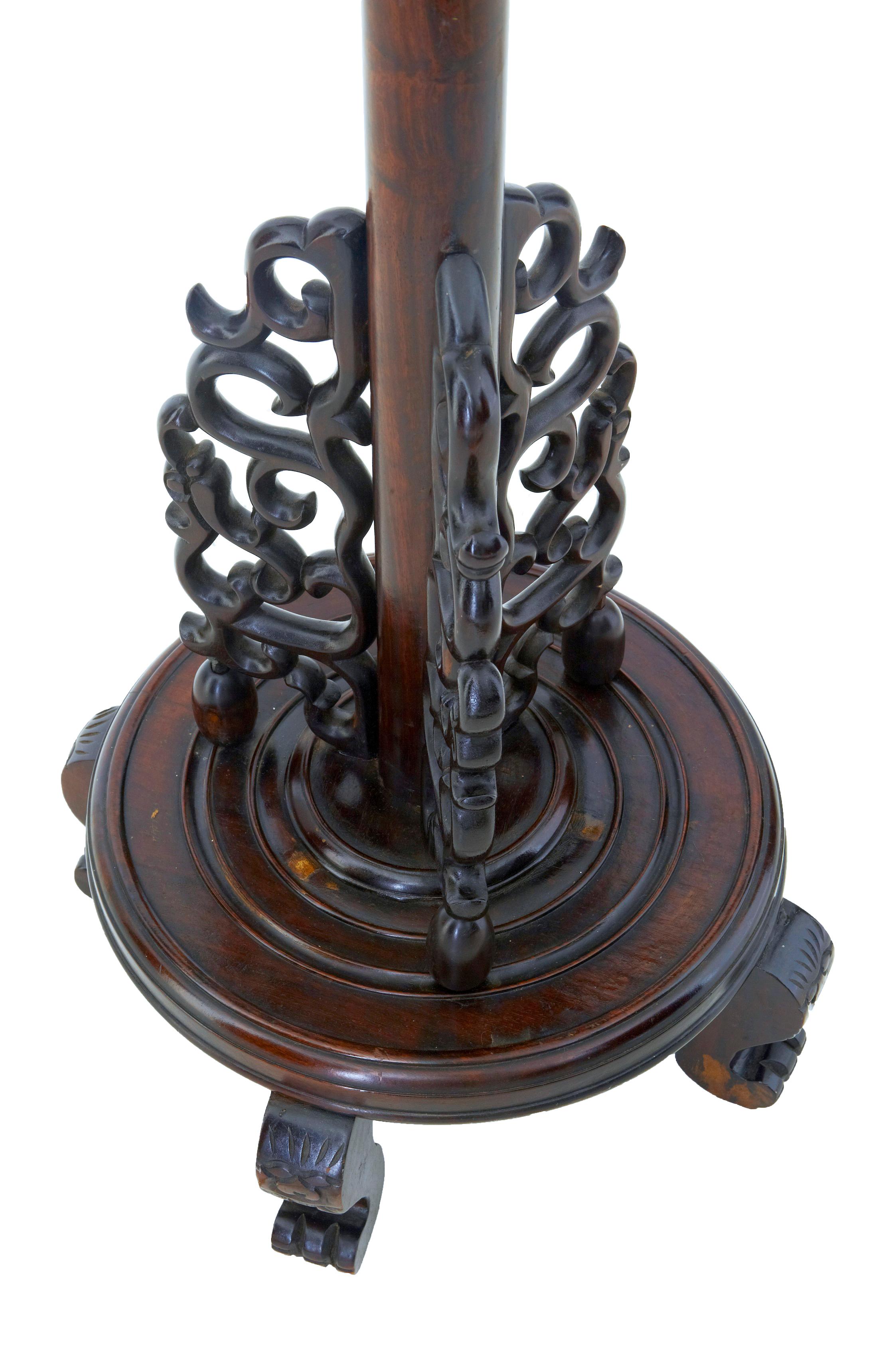 Early 20th century carved Chinese hard wood floor lamp, circa 1920.

Carved in heavy hardwood. Carved dragons head forming the outlet for the light fitment, long stem leading down to 3 scrolled carved elements, round base, standing on 4 feet. This