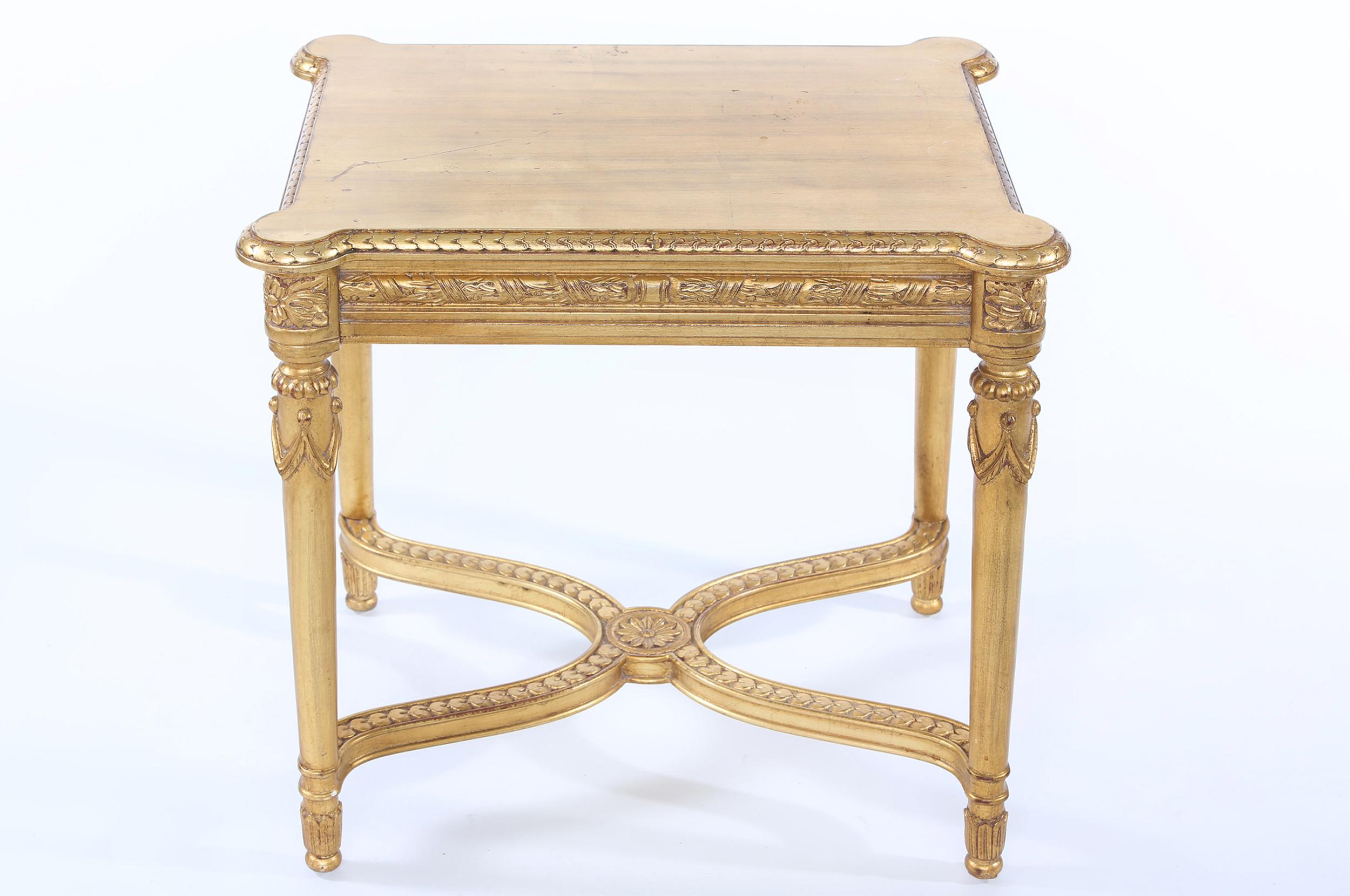 Early 20th century giltwood end / side table with finely carved exterior base design details. The end / side table is in great condition. Minor wear consistent with age / use. The table stands about 24 inches high x 26 inches long x 21 inches
