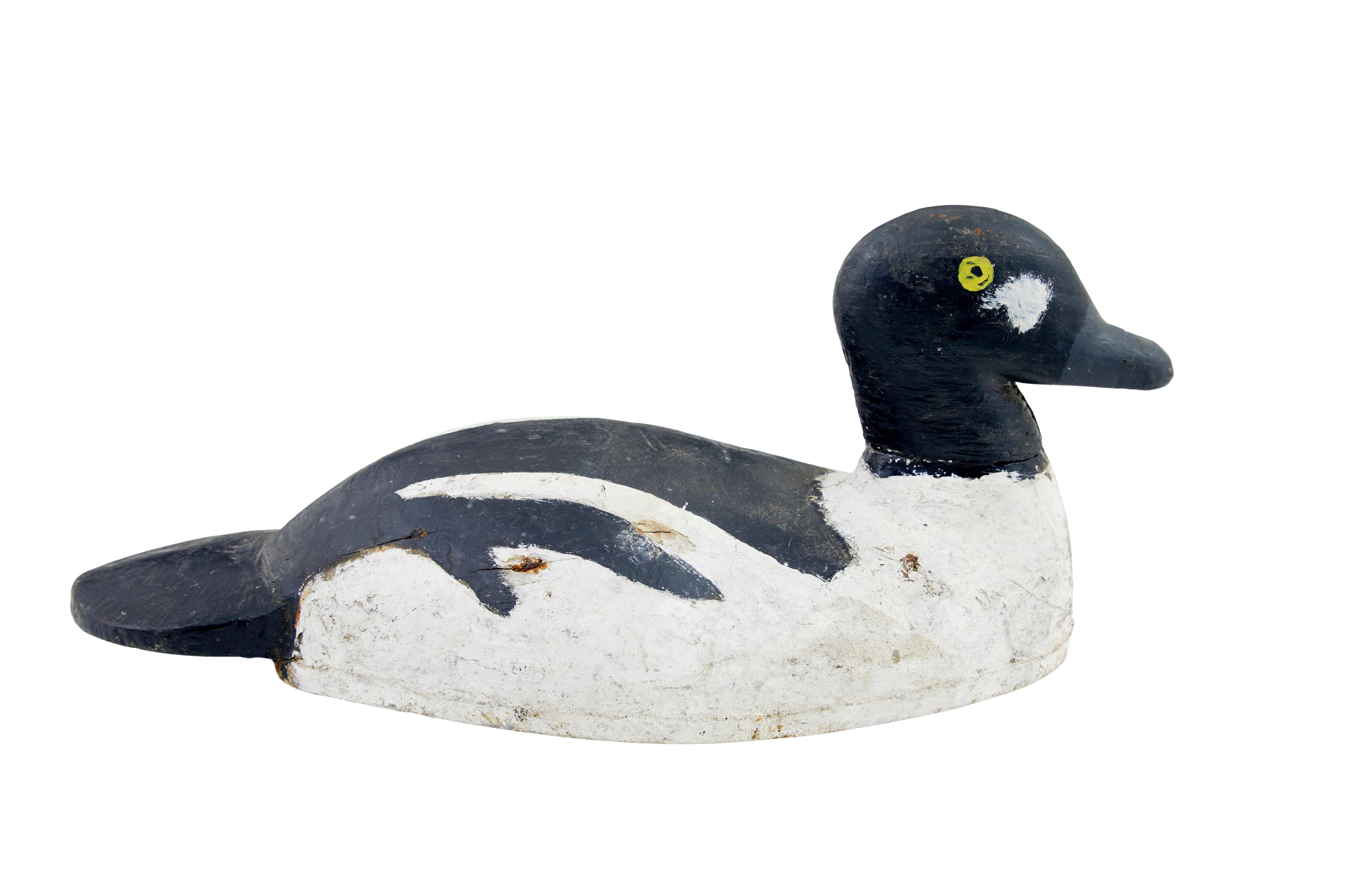 Early 20th century carved hand painted decoy circa 1920.

Hand painted Scandinavian decoy duck, black and white paint scheme with yellow eyes.   Fine example of how things used to be done, now making a great display item.

Expected paint losses and