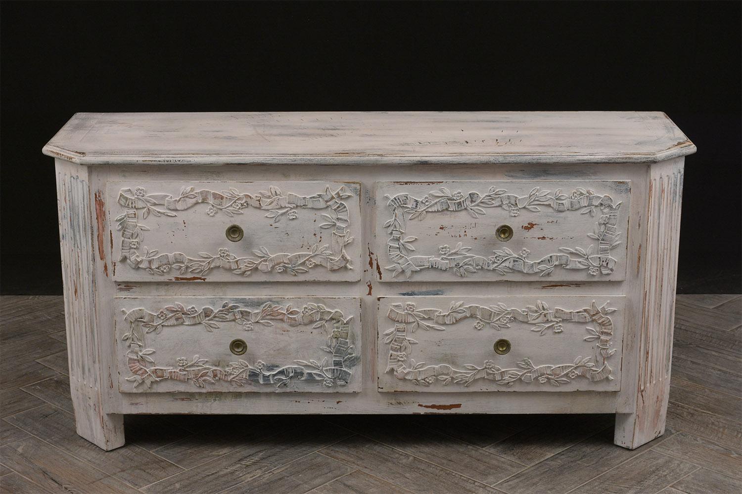 This 1920s Italian chest of drawers is one of a kind, the beveled wooden top and wooden frame have recently been painted in an oyster and red color combination with a beautiful distressed finish. On the facades of the four drawers there are floral
