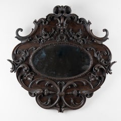 Miroir ovale en chêne foncé sculpté du Portugal du début du 20e siècle