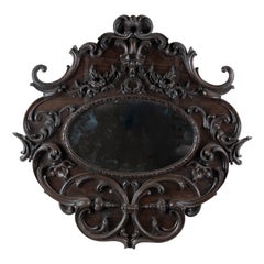 Miroir ovale en chêne foncé sculpté du Portugal du début du 20e siècle