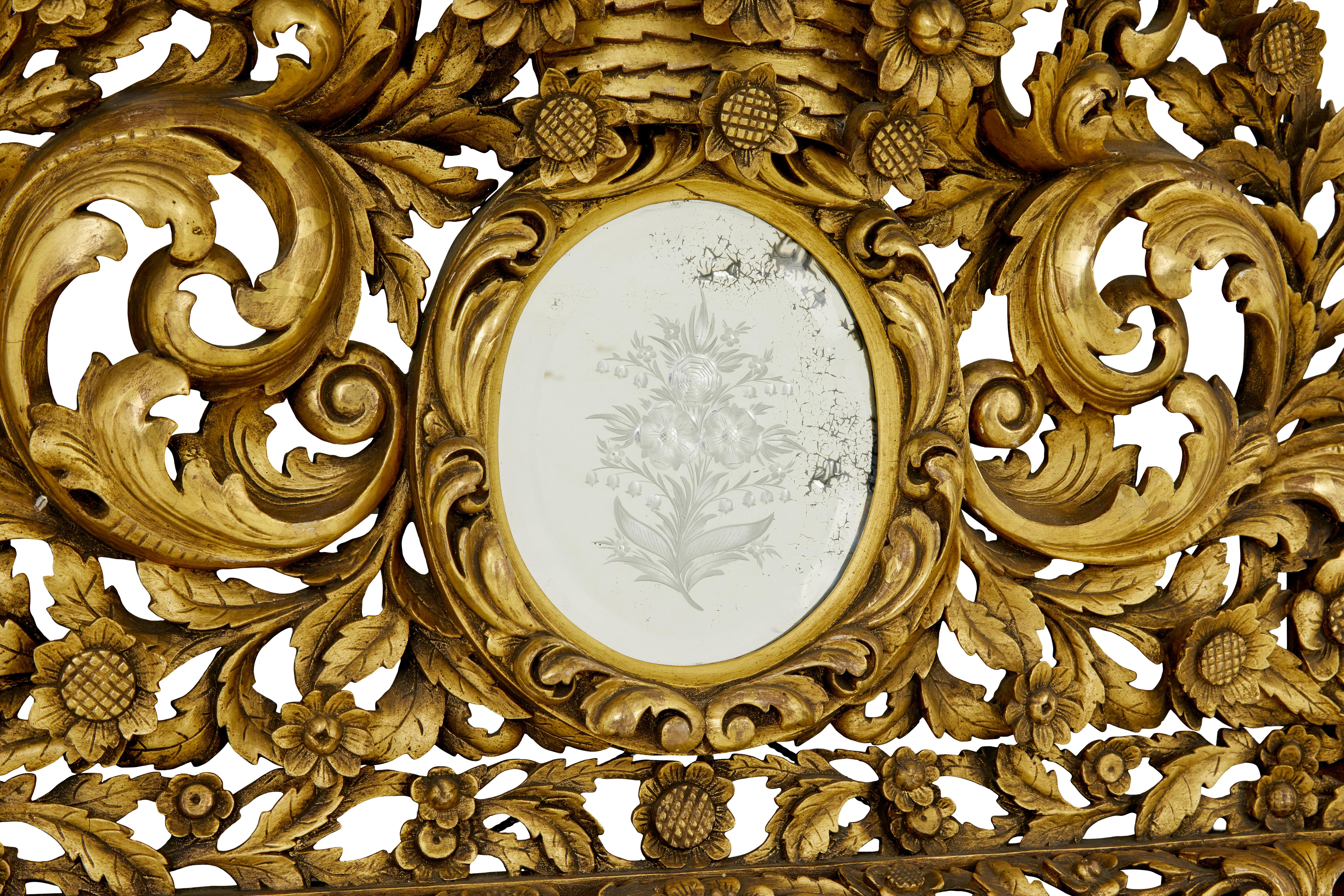 Large early 20th century carved wood baroque influenced cushion mirror circa 1905.

Stunning baroque influenced cushion mirror of large proportions.   Profusely carved with swags and acanthus leaves.  Removable top section with small etched oval