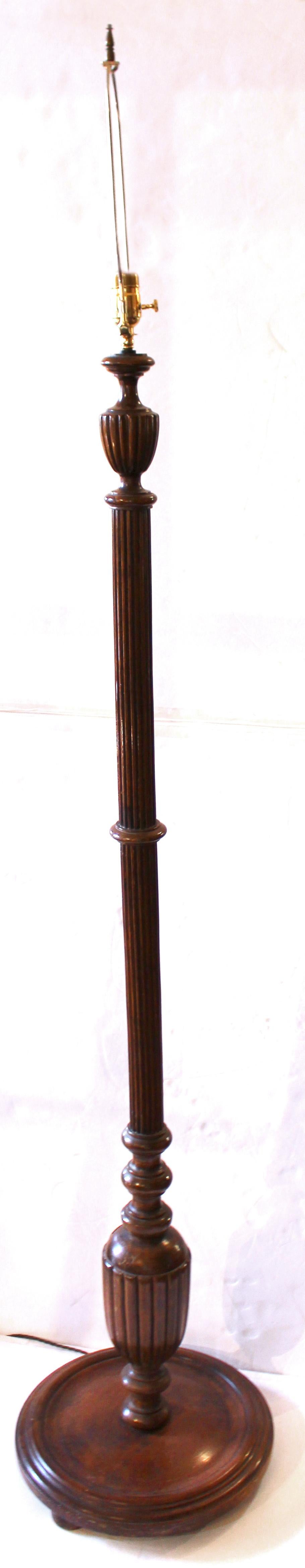 Early 20th century carved wood floor lamp, English. Likely made from a much earlier bed post or torchiere. Mahogany. The shaft well reeded ending in bulbous turnings and disc base. Slight warp in the shaft, noticeable from one direction but not the