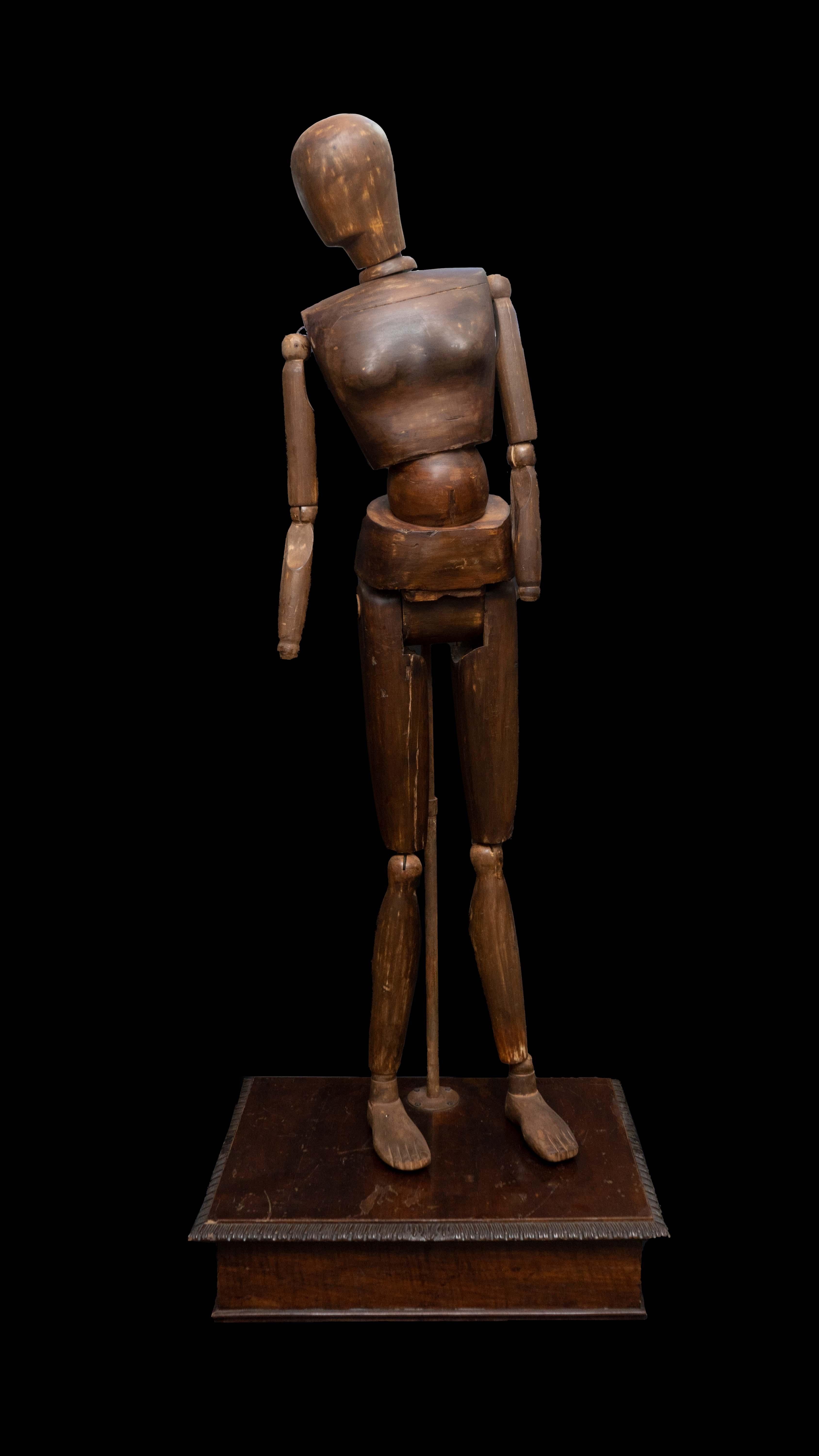 A rare and interesting carved wood mannequin resting on a carved wood base from the first part of the 20th century.