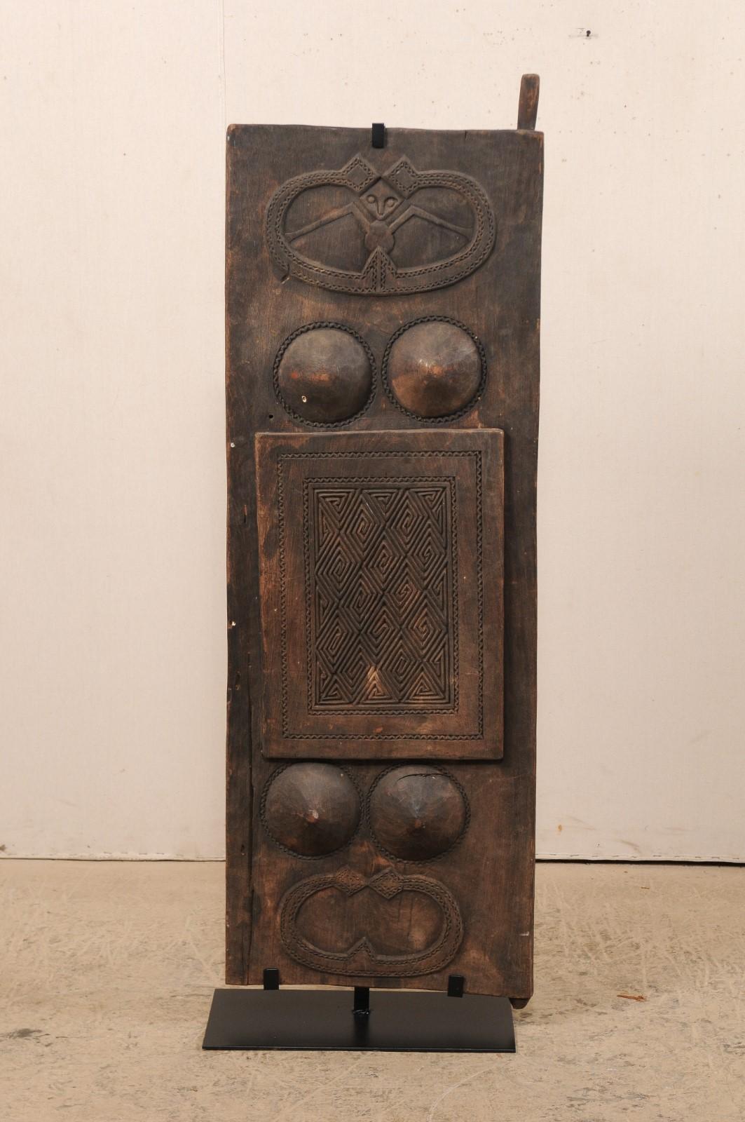 An early 20th century carved wood door panel from Timor Island in the Indonesian archipelago. This antique wall panel from Timor Island (an island at the southern end of Maritime Southeast Asia, north of the Timor Sea) has been hand carved with two