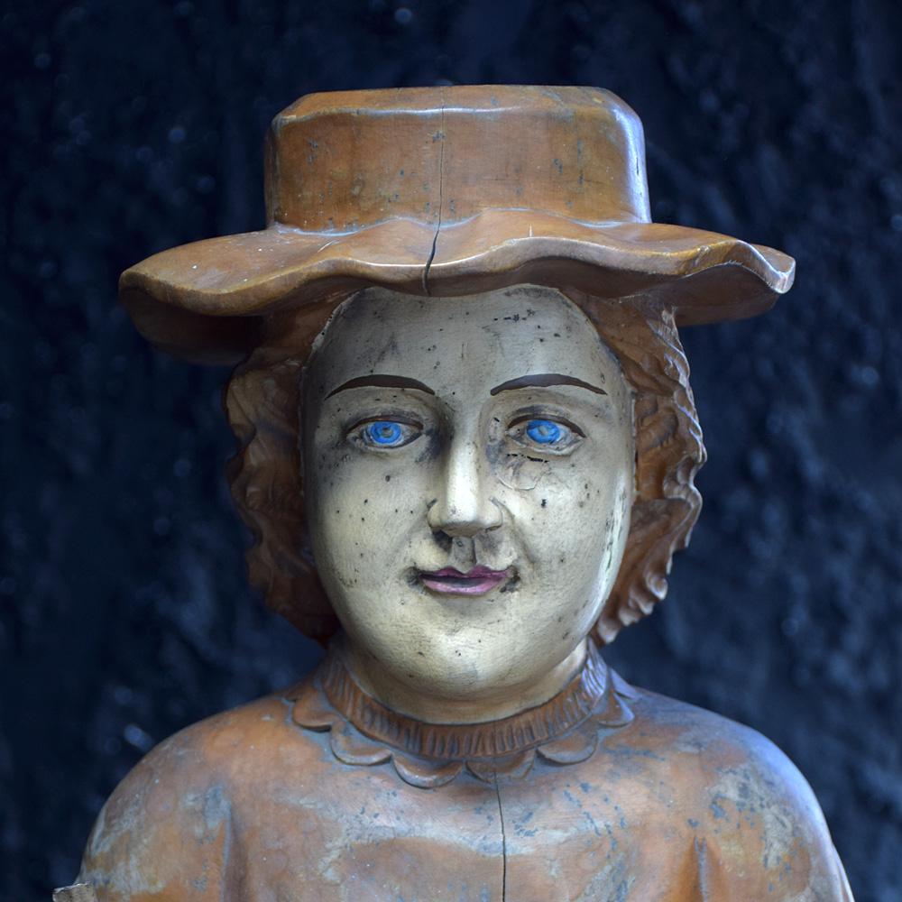 The Mormon
We are proud to offer a unique hand carved early 20th century figure of a traditional Mormon. Wonderfully carved from a single piece of hard wood, detailing an angel at the base of his feet. The figure would likely have held a stick