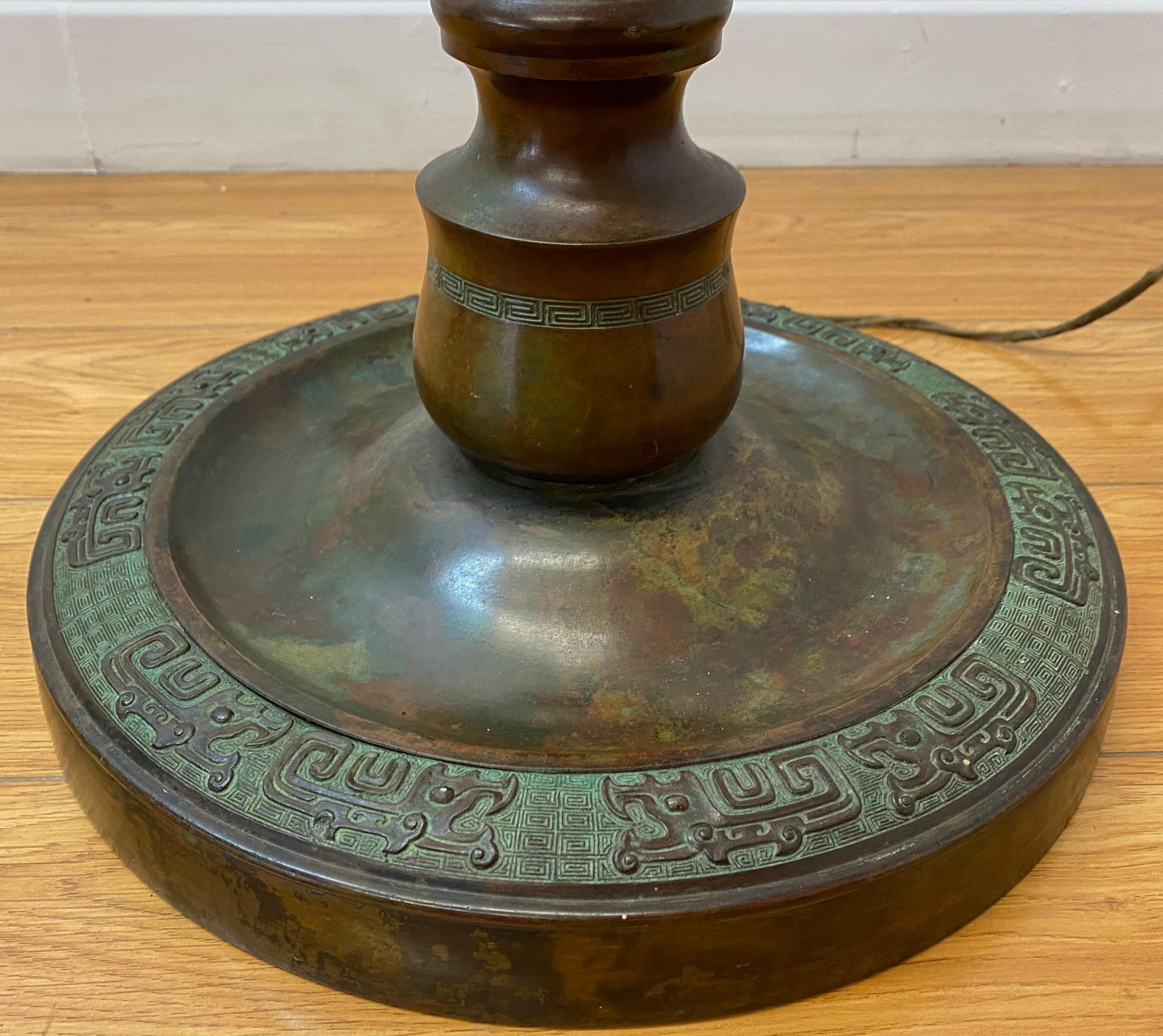 Early 20th century cast bronze floor lamp with neolithic Chinese motif

13
