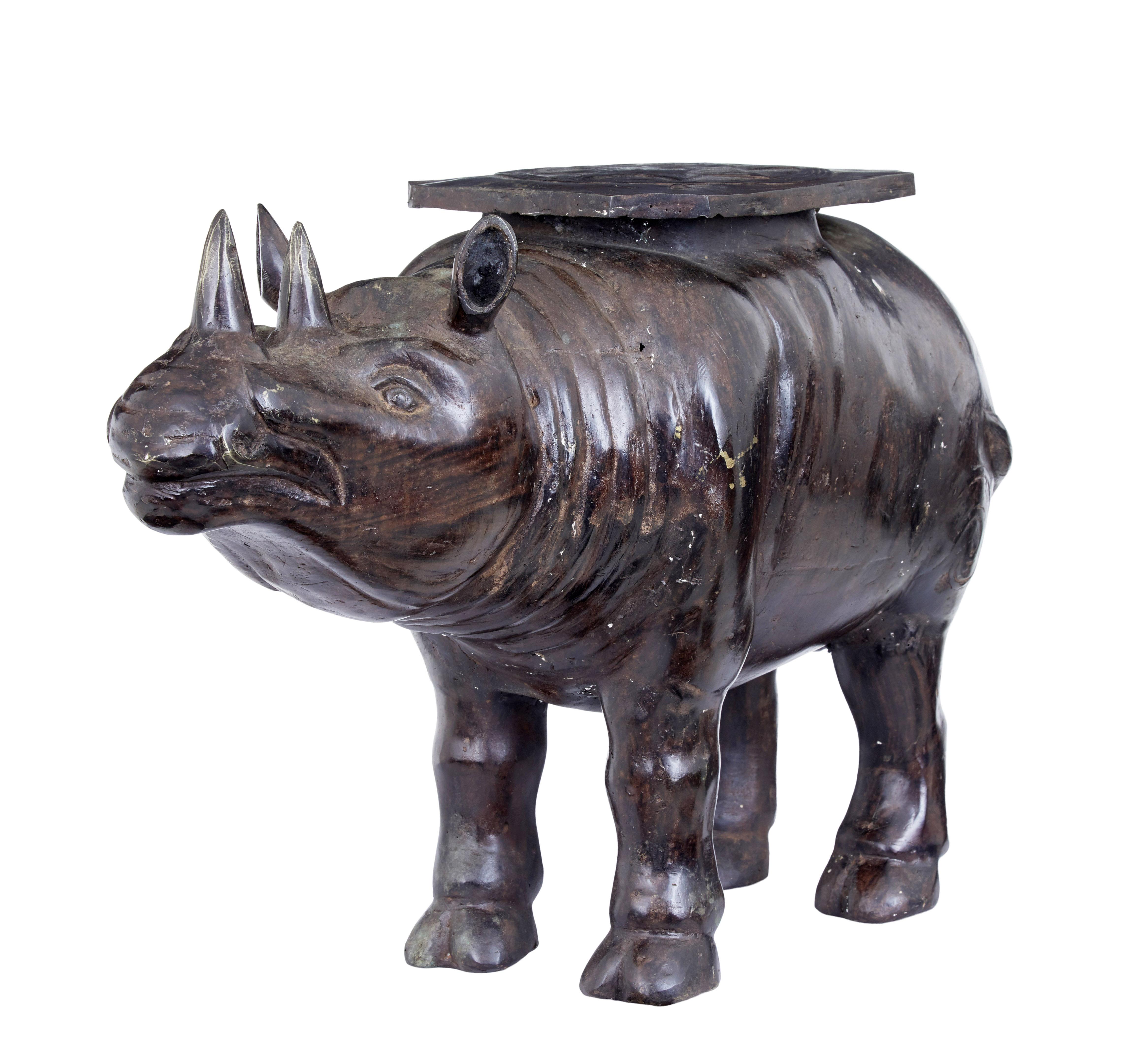 Early 20th century cast bronze rhino occasional table, circa 1920.

Delightful cast bronze eastern region side table in the form of a rhino. Superb quality minature rhino with a octagonal serving surface on its back, decorated with a star