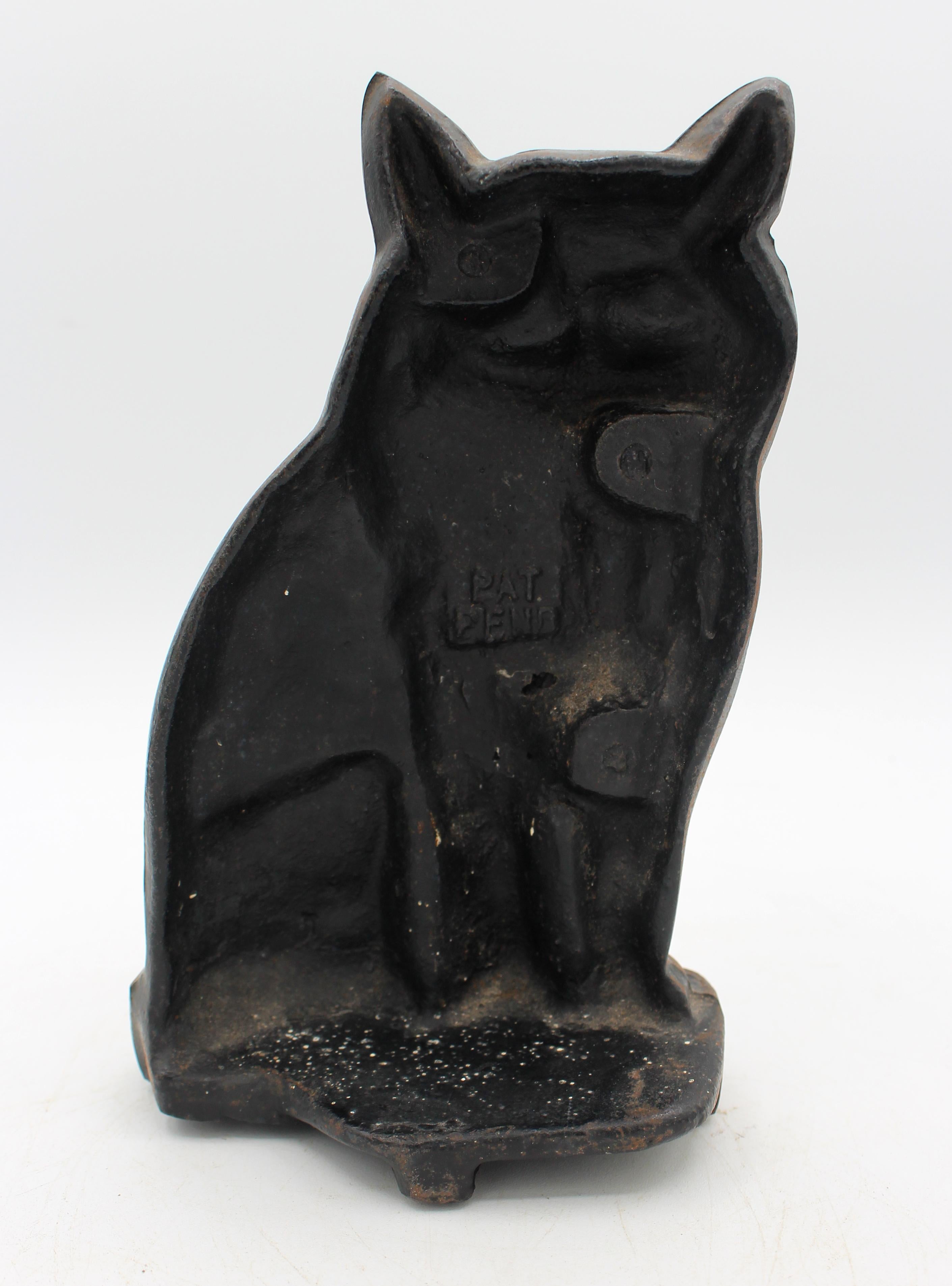Early 20th century cast iron cat doorstop, English. Charming face, small but heavy. Paint wear only makes it more charming! Well modelled. 7