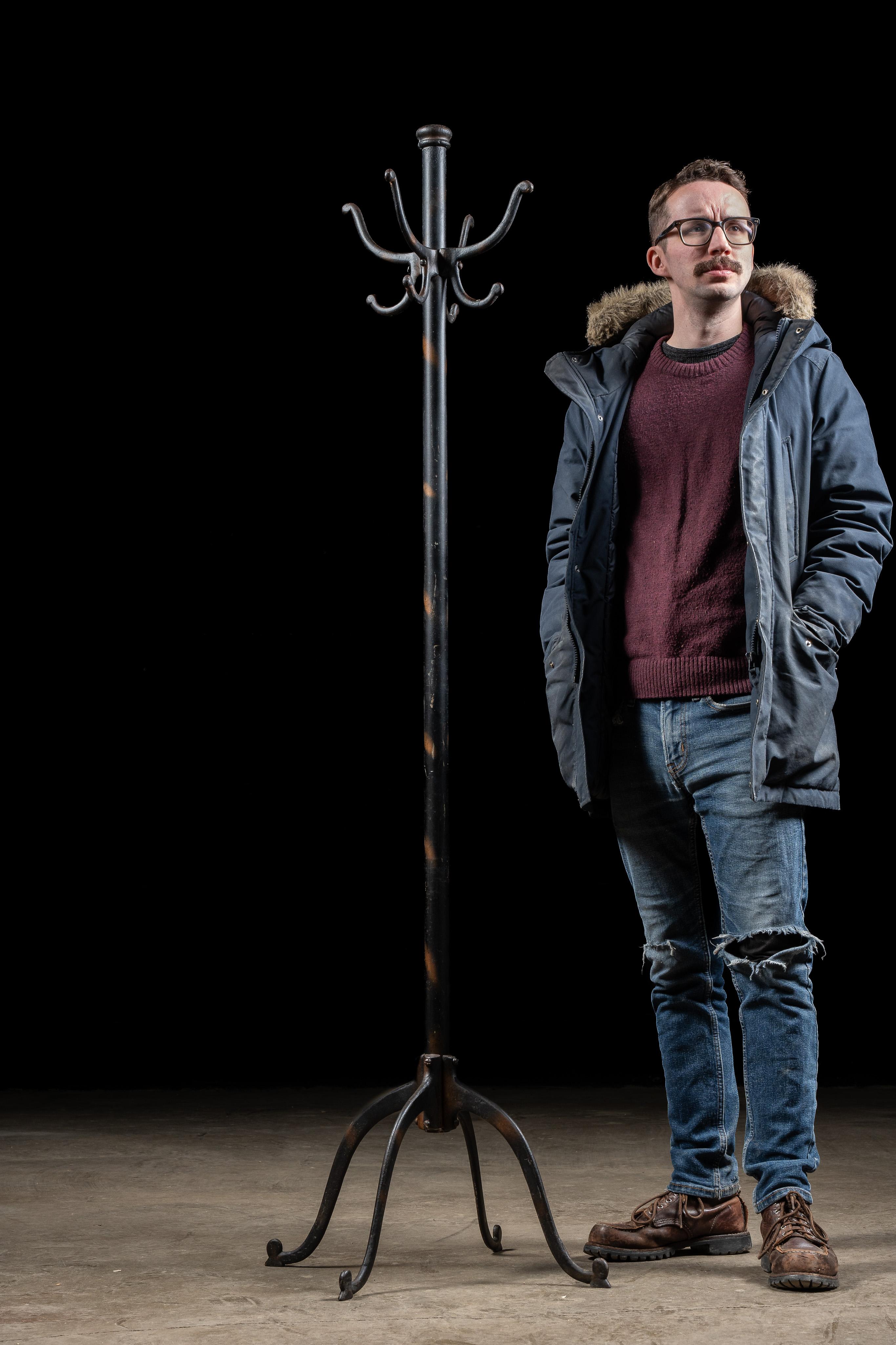 Antique cast iron coat tree.

Despite its appearance, this coat rack not japanned copper, although it gets marks for accurately recreating the look. It sits on a quartet of splayed legs and features four sets of double hooks.

23