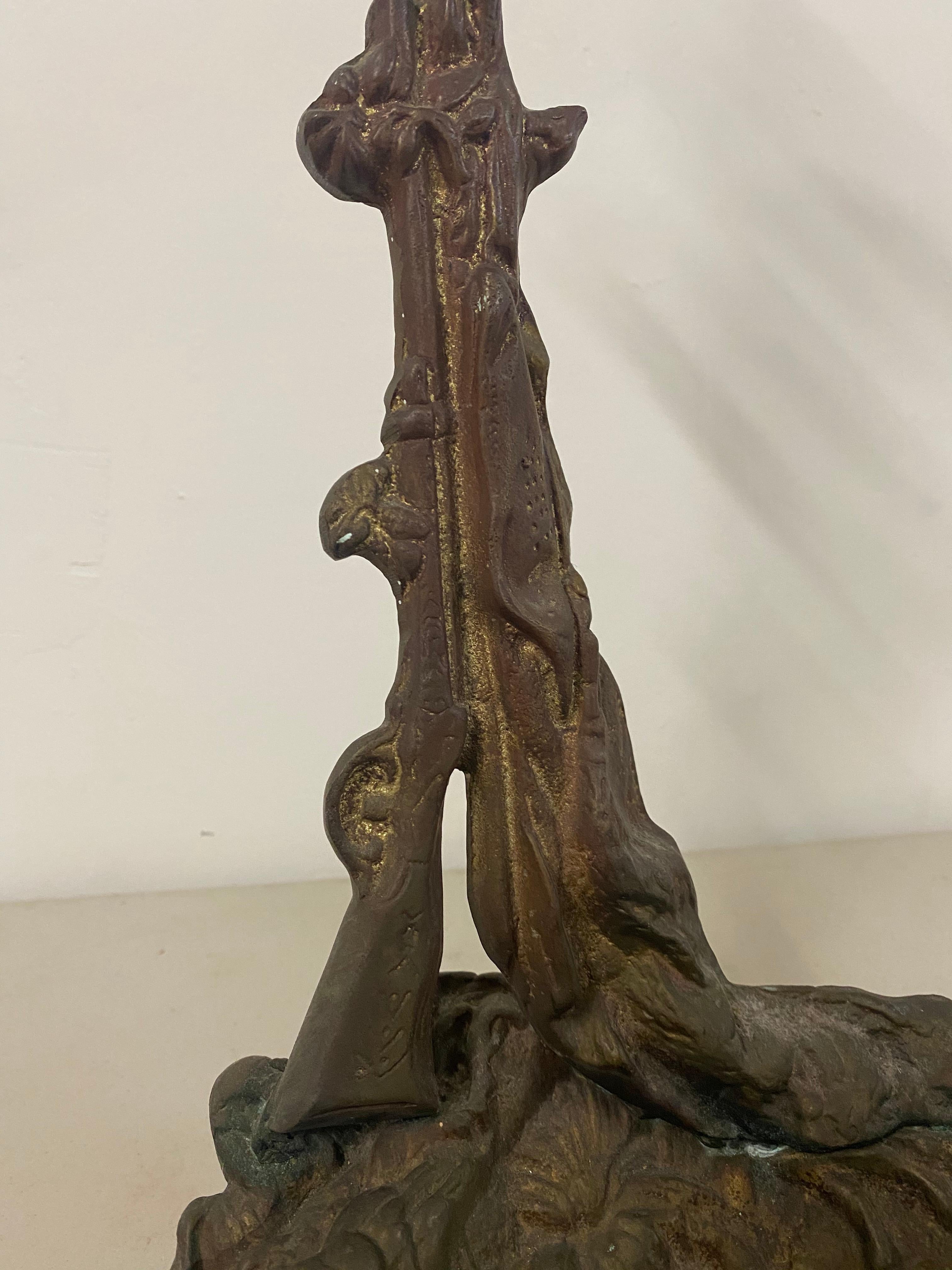 Early 20th century cast iron fireplace tool stand or umbrella stand, circa 1920

Cast iron tool or umbrella holder

A rustic stand with a dog reclining at the front edge and a rifle leaning up against the stand

Dimensions 10