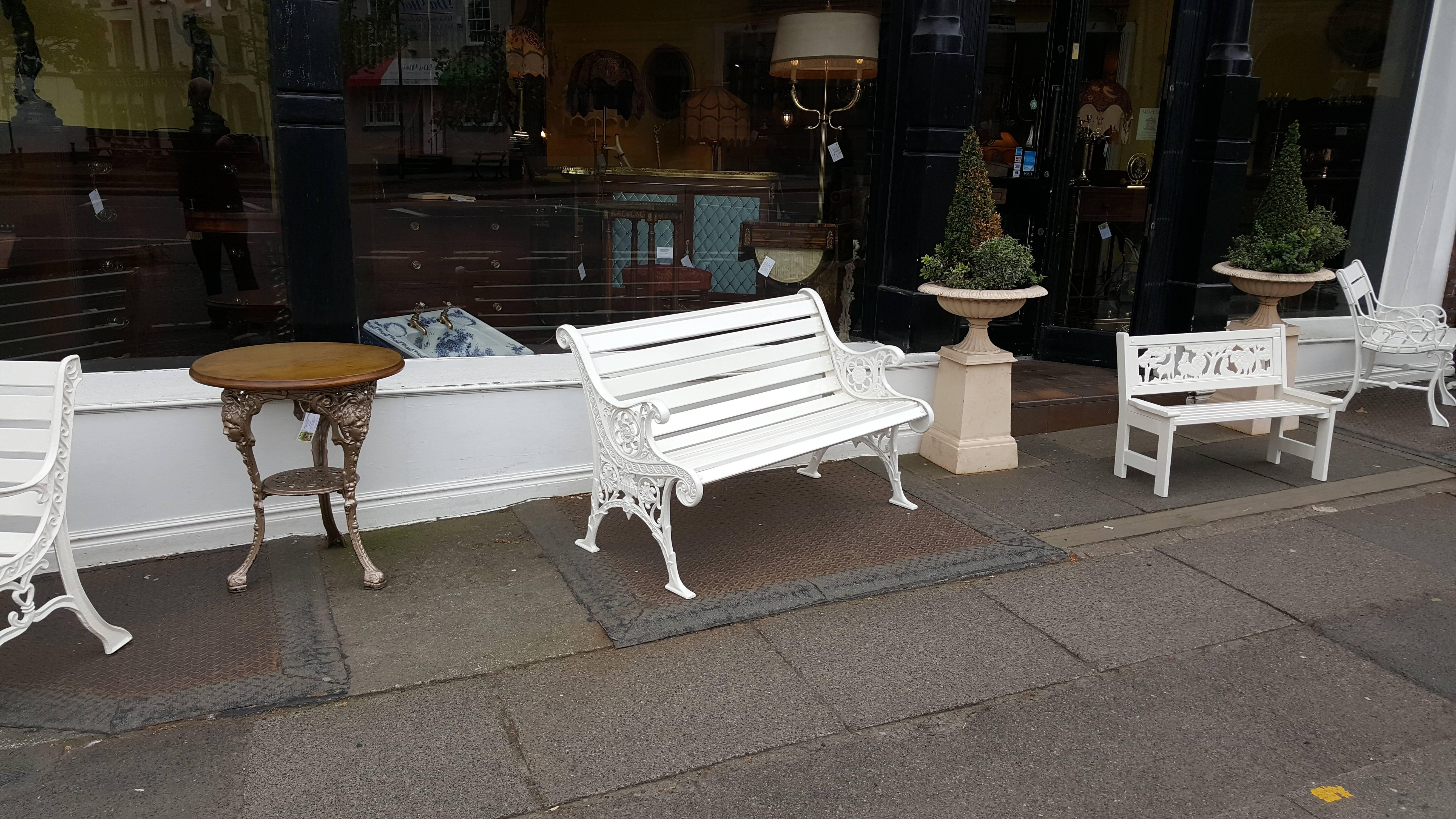 Early 20th century cast iron garden bench, the ends decorated with urns, roses and other foliage - slats are refurbished treated redwood,
47