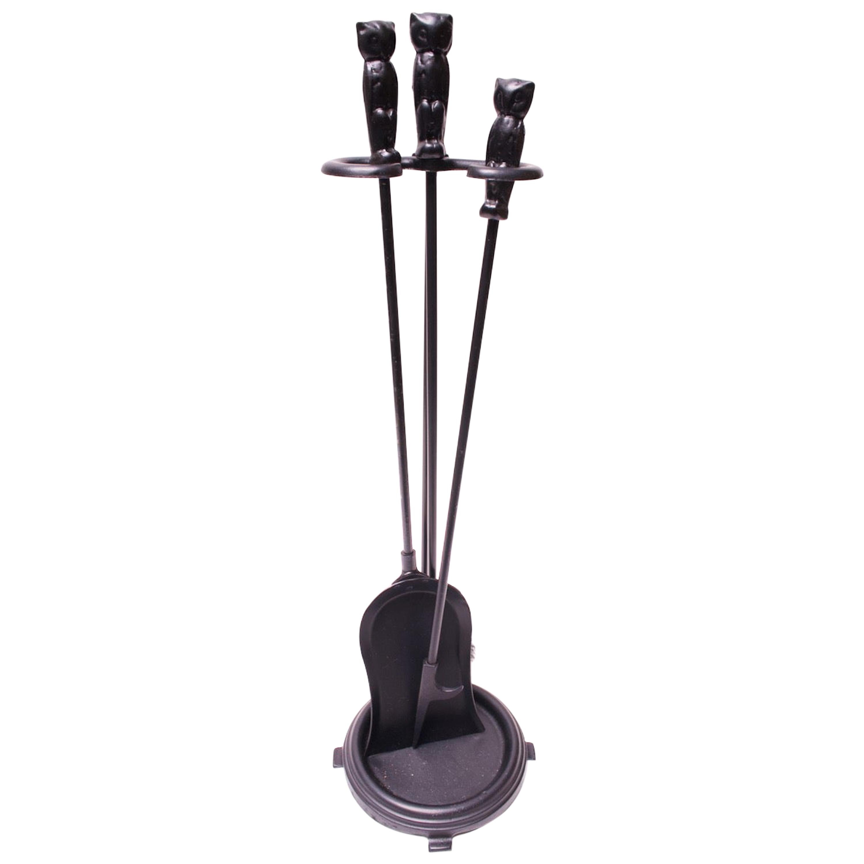 Cast iron fireplace tools forged by Hart Foundry of Massachusetts, circa 1920s. Features a Stand, brush, poker, and shovel, all decorated with an 
