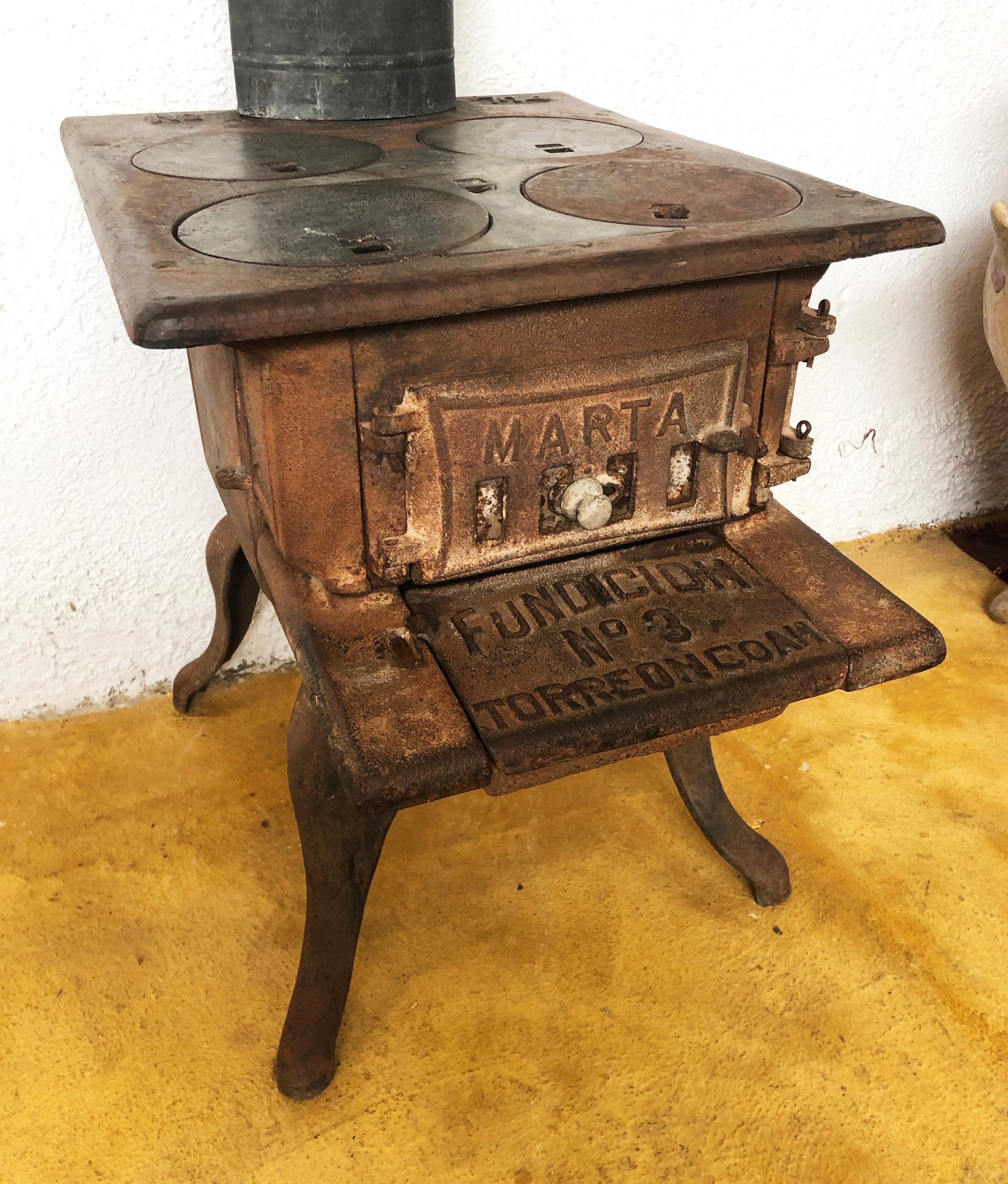 One of the most unique pieces we have found in the last few years is this cast iron French stove with trap doors in many parts of this piece. What a sensational end table this would make next to a chair. The top is flat and the conversations would