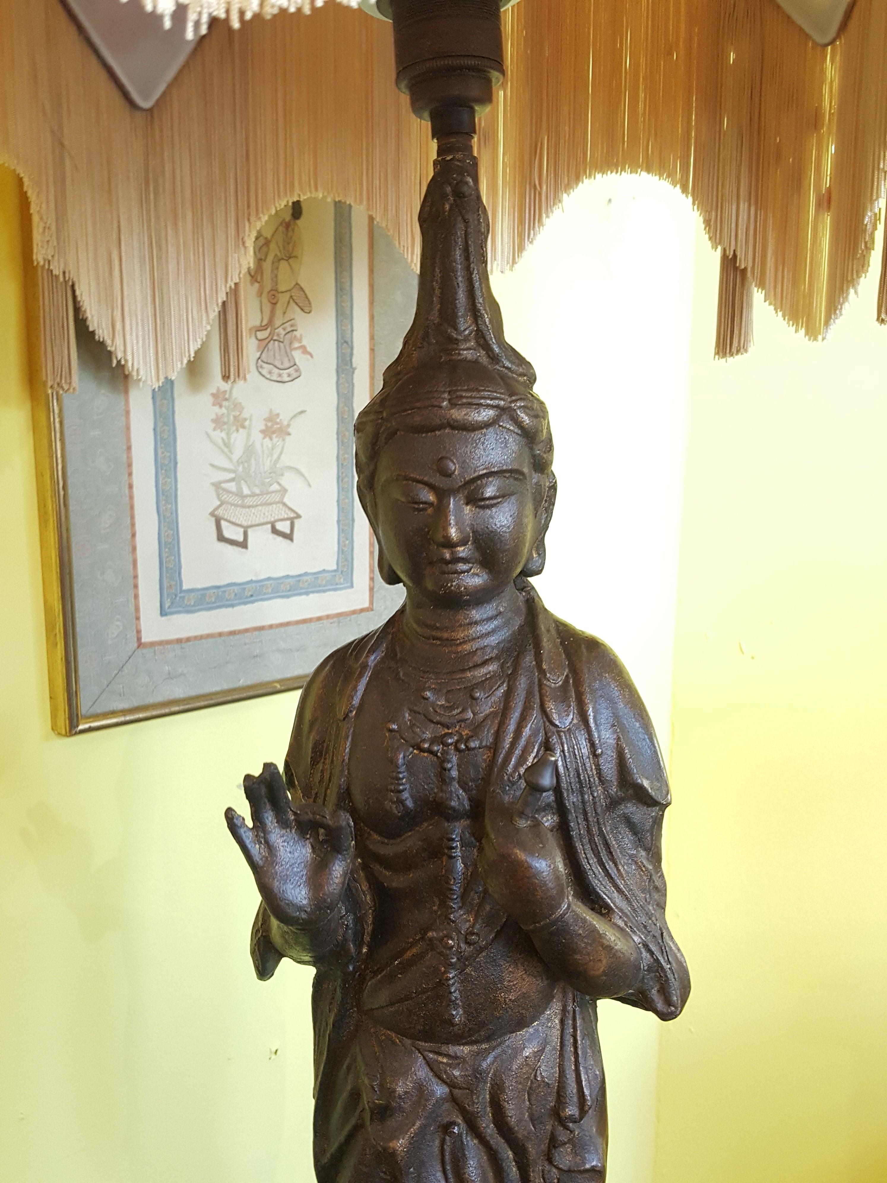 Cast metal figure of Guanyin, early 20th century, standing in Vitarka Mudra upon a double lotus base, in turn above a circular foot, (fitted for electricity). The lampshade(s) are newly handmade silks by the same maker as provides the shades for