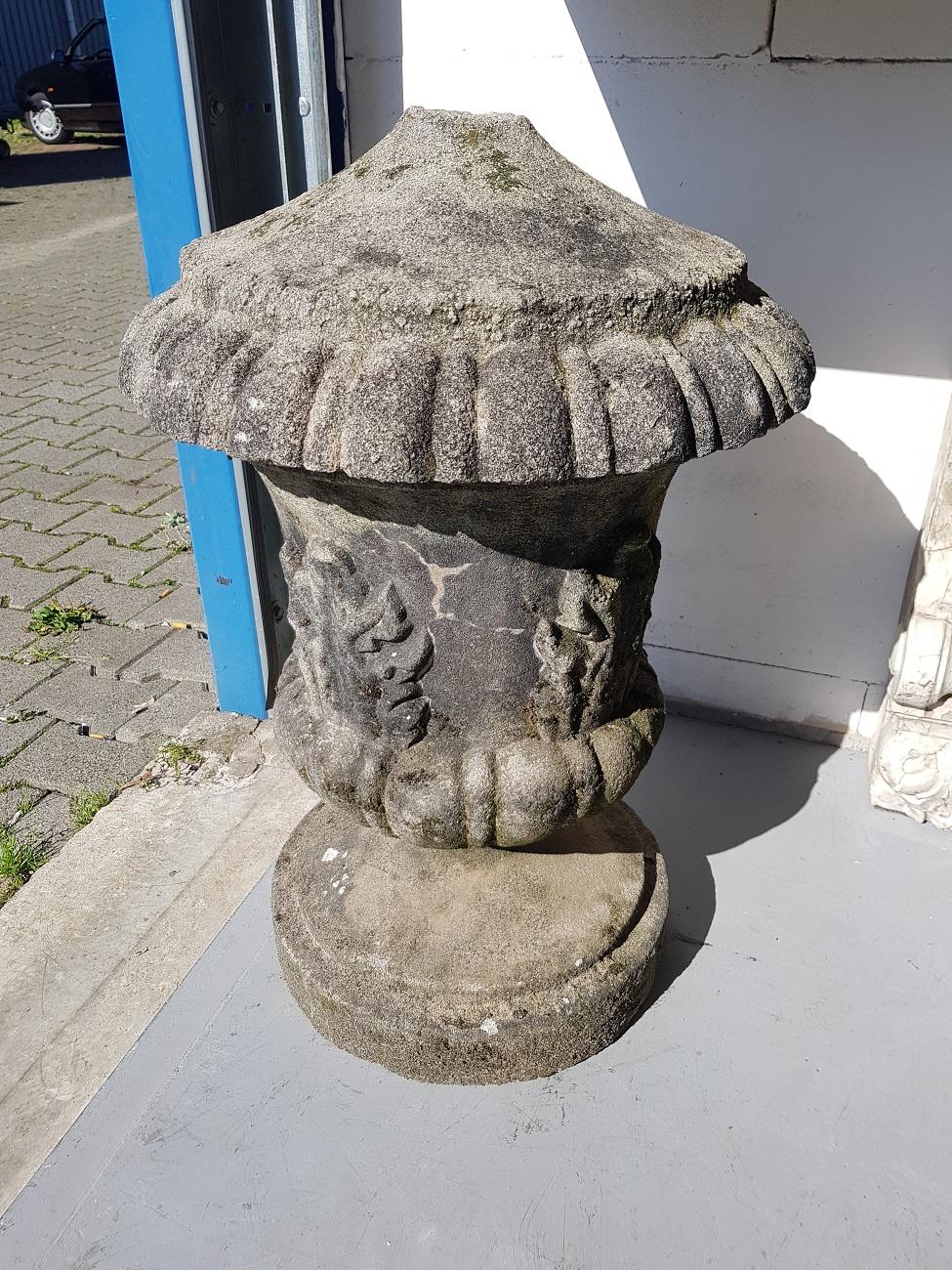 After a antique example a heavy old cast stone vase in the shape of an urn with acanthus leaves all around (top ornament missing), early 20th century.

The measurements are,
Depth 47 cm/ 18.5 inch.
Width 47 cm/ 18.5 inch.
Height 72 cm/ 28.3