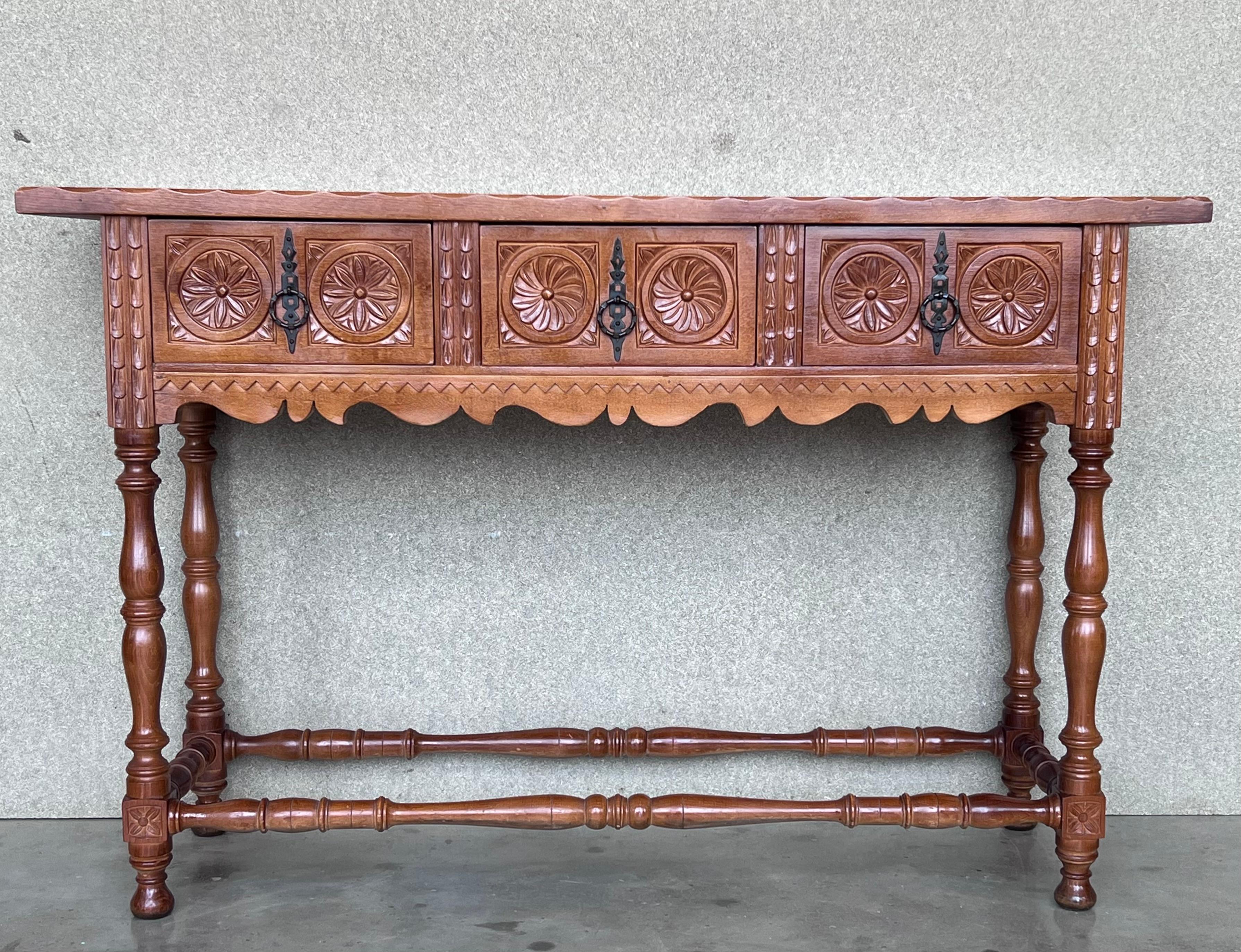 Late 19th century catalan spanish hand carved walnut console table with three drawers.
Very good quality carved Spanish console table, circa 1800-1900. Beautifully carved in walnut with good color and patina. Features three drawers with carved