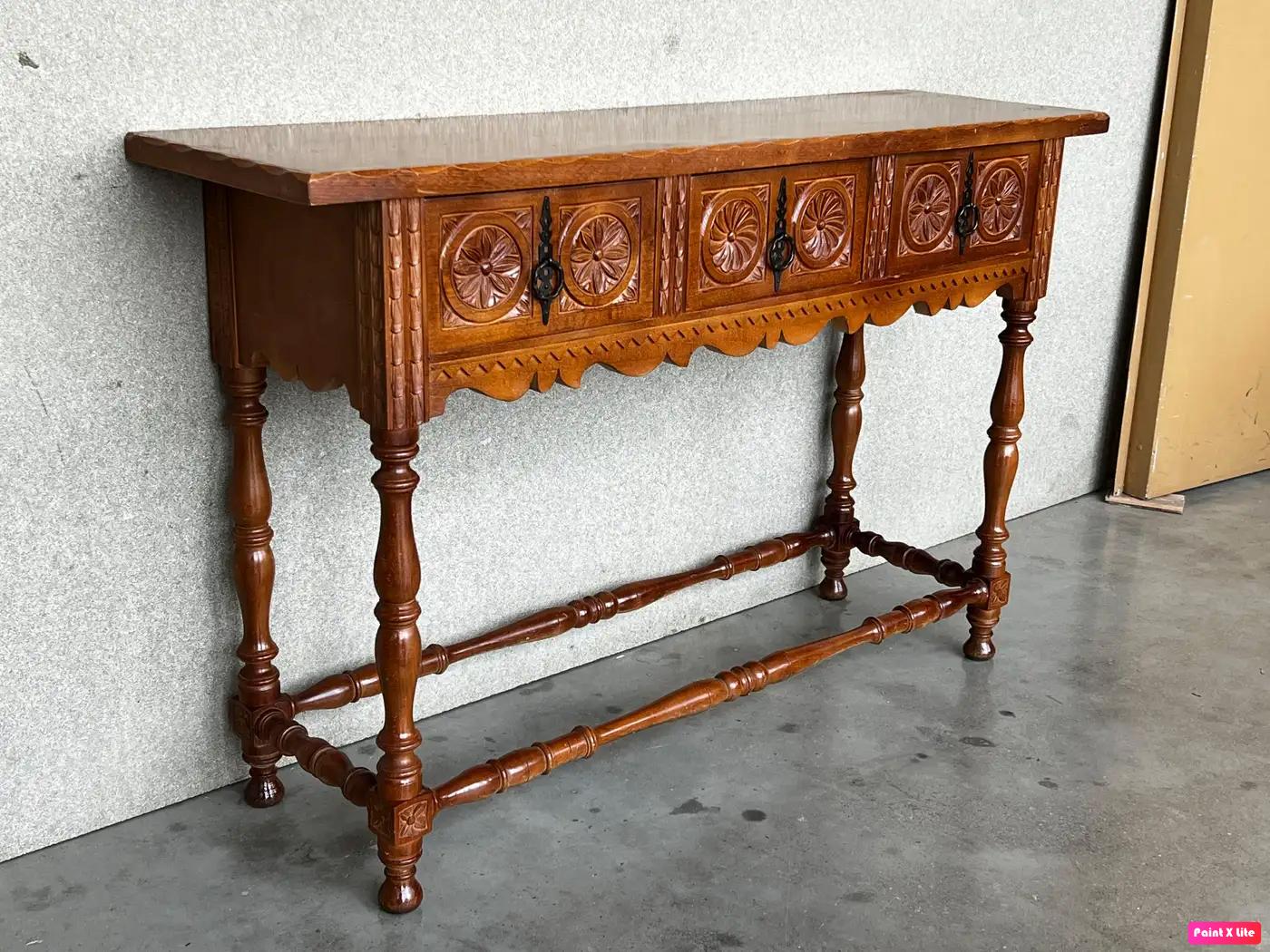 Late 19th century catalan spanish hand carved walnut console table with three drawers.
Very good quality carved Spanish console table, circa 1800-1900. Beautifully carved in walnut with good color and patina. Features three drawers with carved