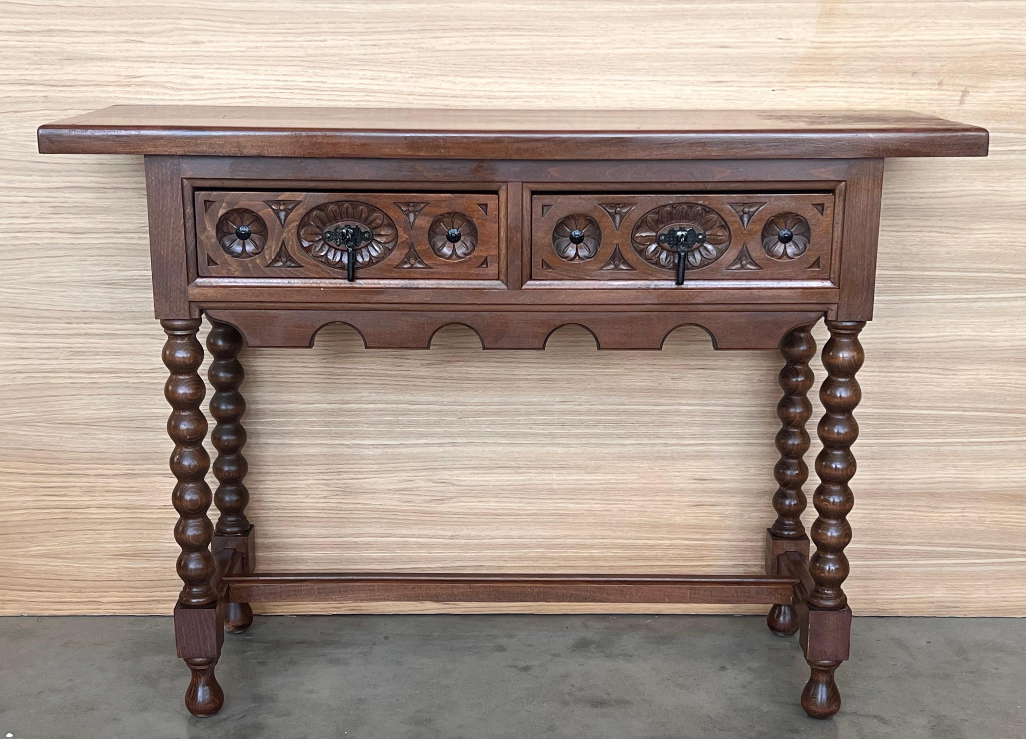 Late 19th century catalan spanish hand carved walnut console table with two drawers.
Very good quality carved Spanish console table, circa 1800-1900. Beautifully carved in walnut with good color and patina. Features two drawers with carved