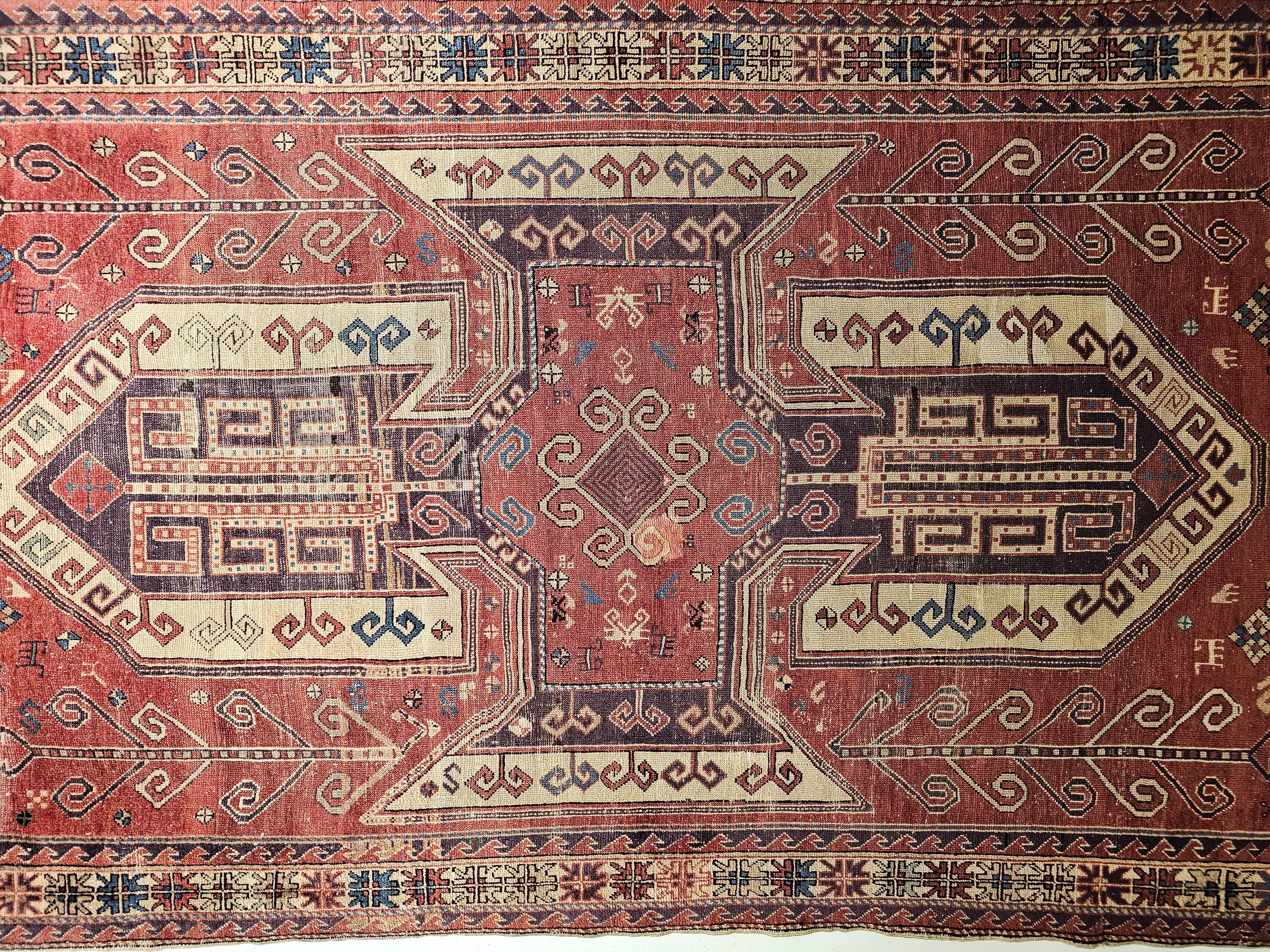 A beautiful Caucasian Sevan Kazak from the early 1900s.  This Kazak is unusually large with the “Sevan” pattern set in a dark red color field.  The large medallion design is in purple, dark red, and ivory colors with geometric design elements in