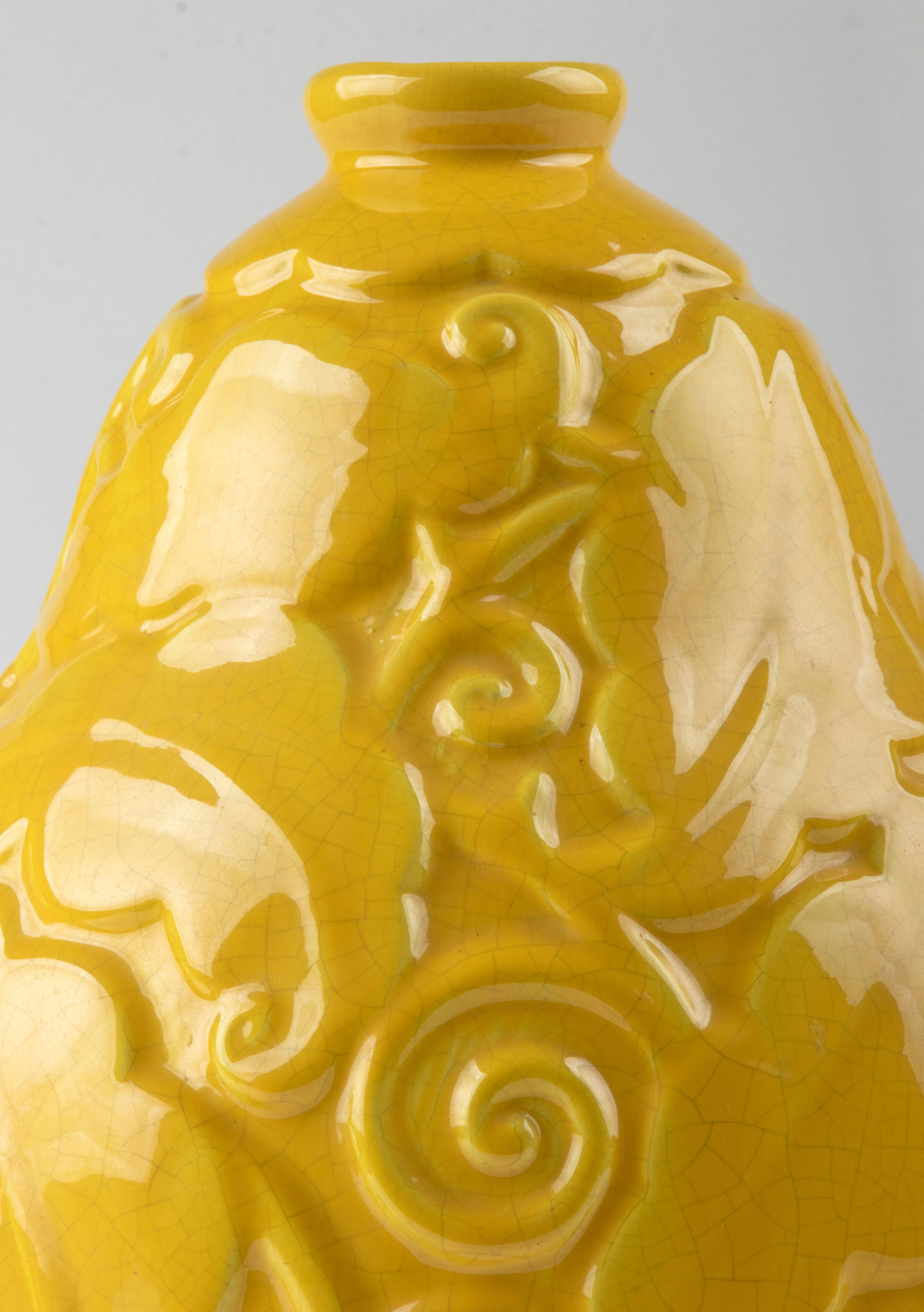 Large ceramic vase by the French maker Saint-Clément from the Art Deco period. The vase has the shape of a gourd, with beautiful stylized relief decorations in a typical Art Deco style. Striking (rare) yellow color. Marked on the bottom, model