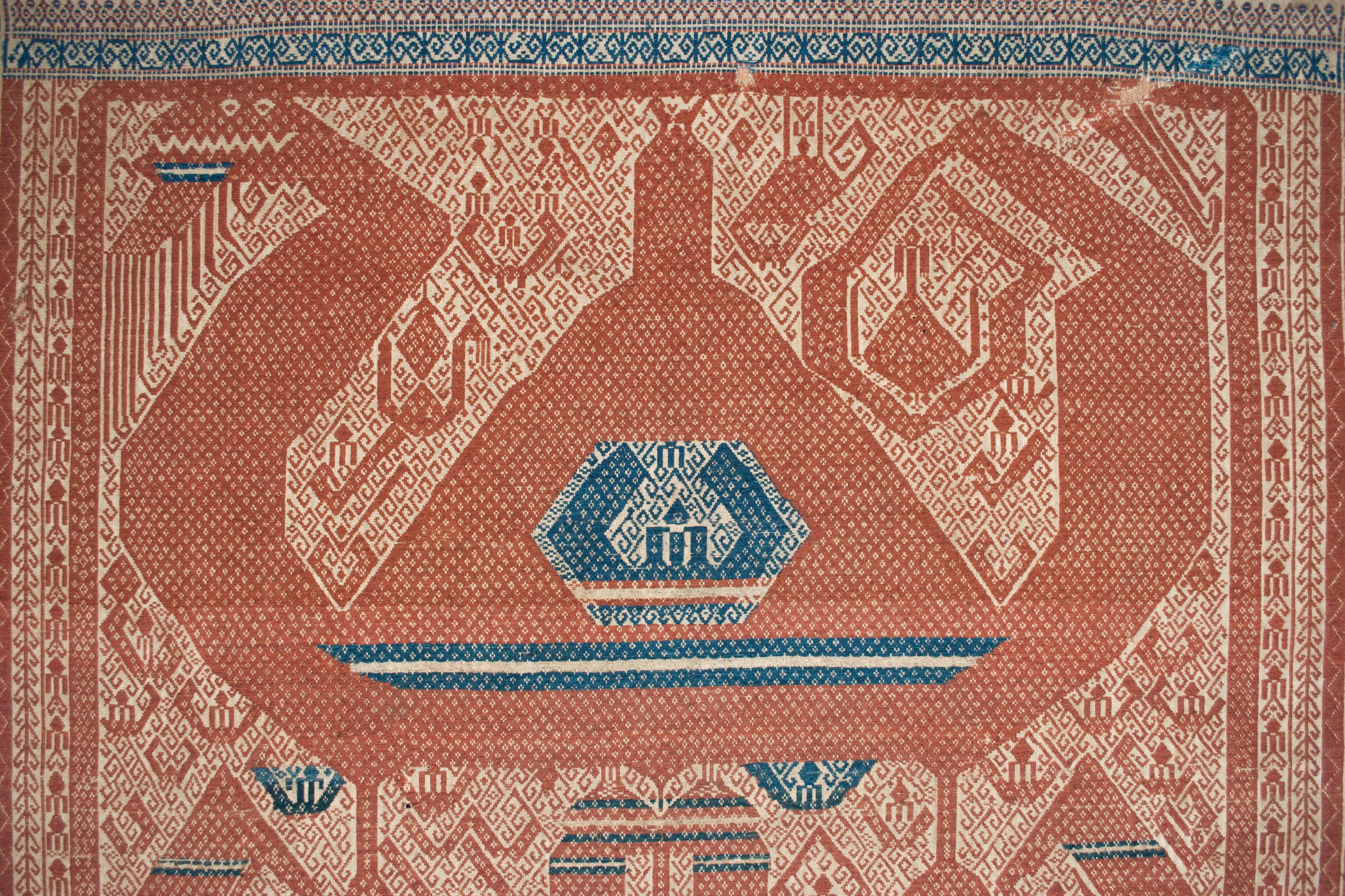 Early 20th century ceremonial cloth (tampan), Lampung, South Sumatra, Indonesia

This large tampan from the Paminggir people contains a dramatic rendering of the mythical serpent/dragon motif above, two smaller beasts below, and a scattering of