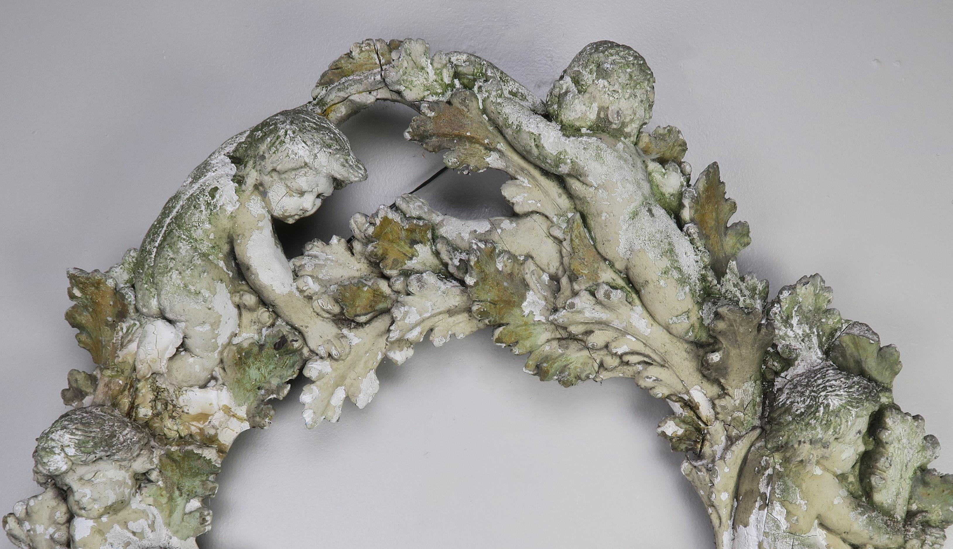 Early 20th century fragment made of chalk and gesso. The beautiful remnant of a larger piece depicts cherubs and acanthus leaves throughout. It would be beautiful on a wall as decor or it would be great in your garden or outside area.