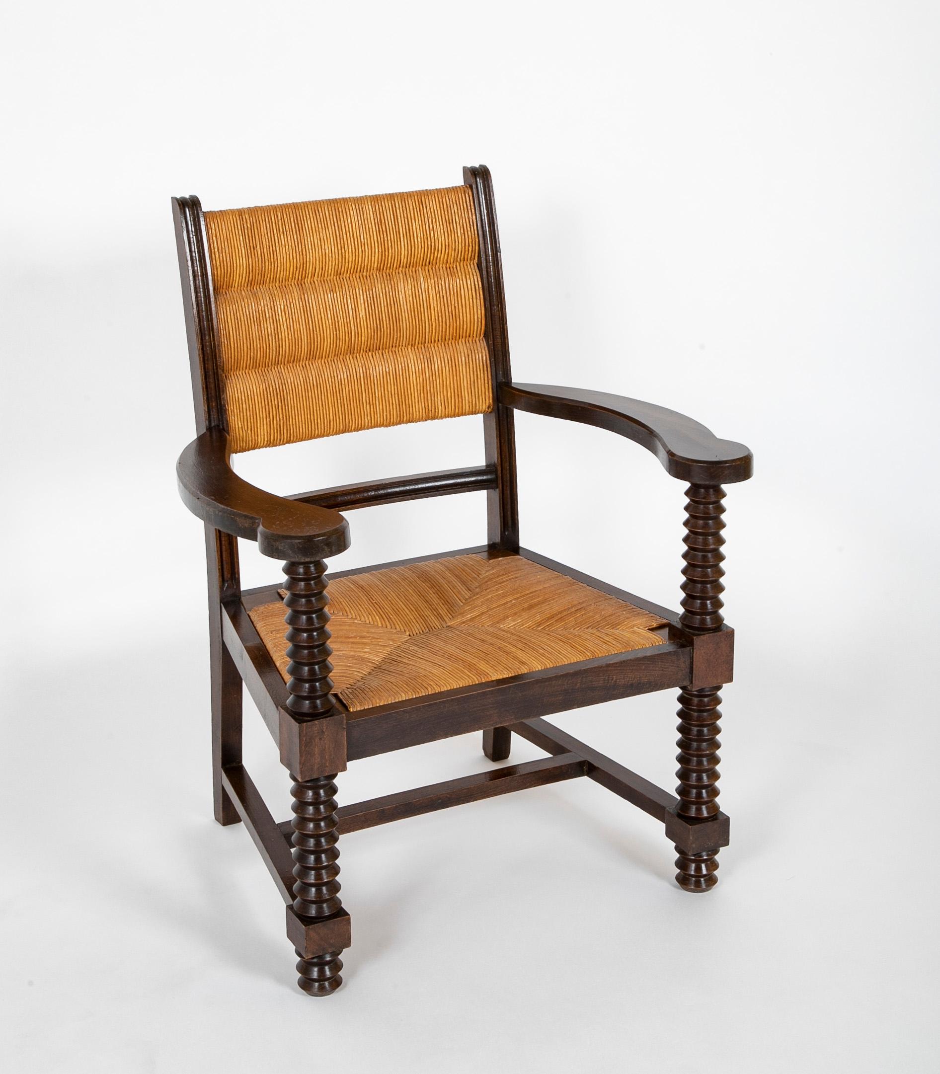 Early 20th century Charles Dudouyt ( 1885 - 1946 ) armchair with straw seat and back, spindle front legs and arms. France.