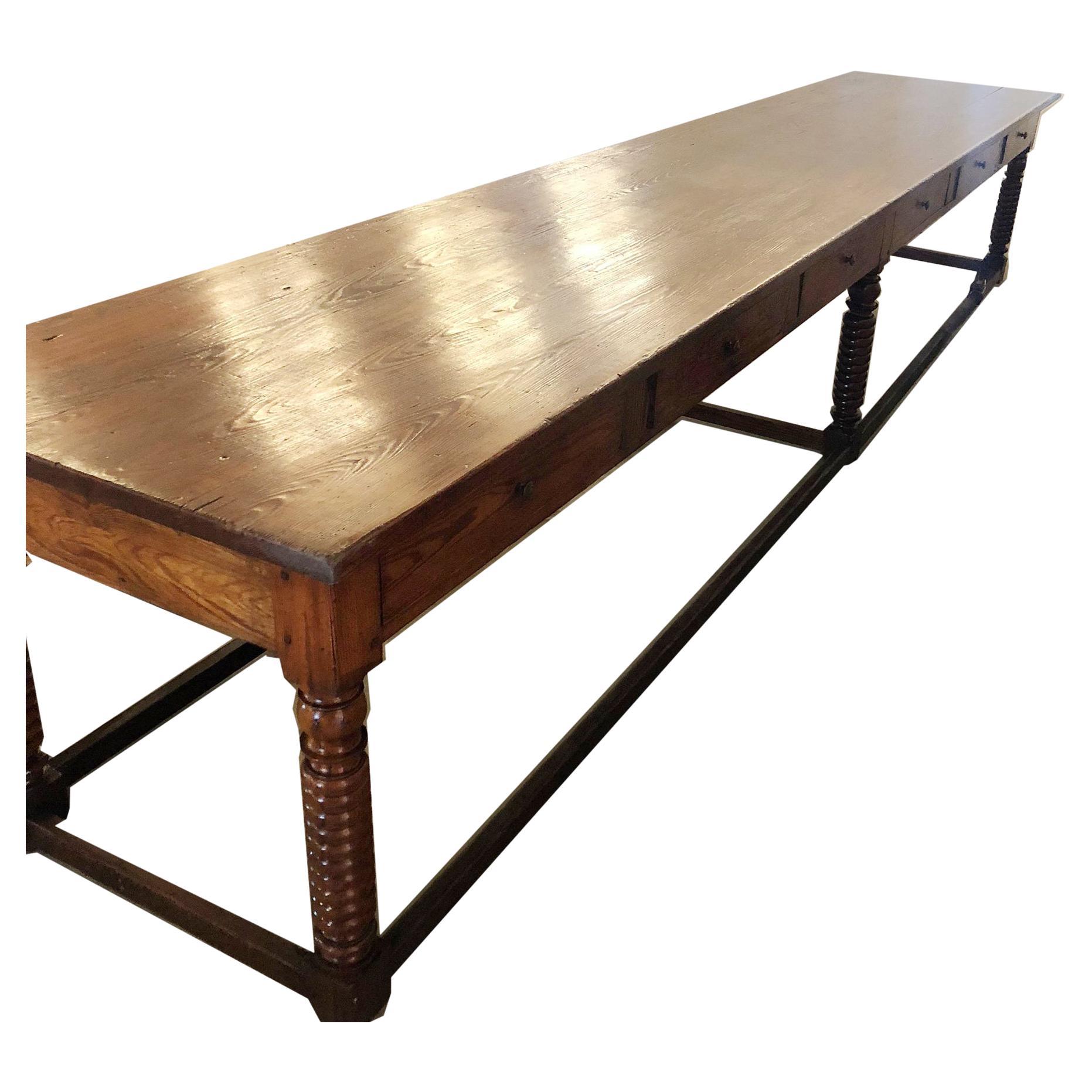 This is a traditional long chateau kitchen table in pine with six drawers that extend the width and depth of the table. 
If you've seen the movie VATEL from 2000 you'll understand the meaning of a 15-foot long kitchen table. This film shows the
