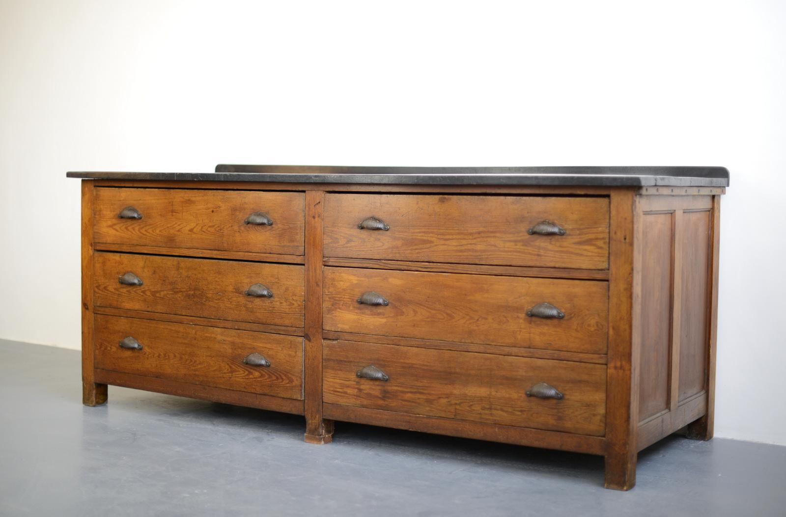 Early 20th century chemists cabinet, circa 1900

- Ebonised mahogany plank top
- Pine drawers and body
- Ornate cast iron handles
- Dovetail jointed drawers
- Originally came from a chemists in Edinburgh
- Scottish ~ 1900
- 216cm long x 86cm