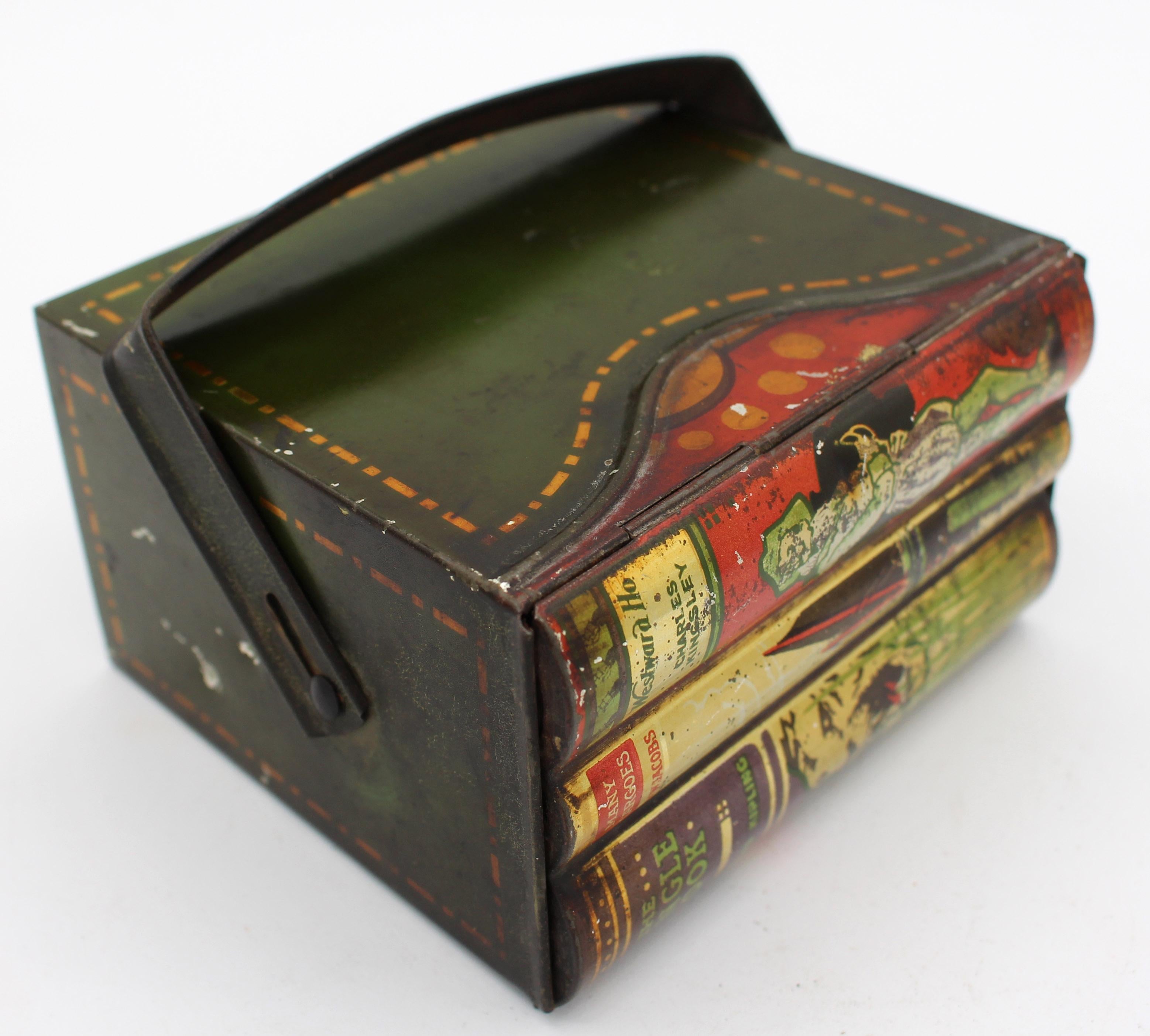 Child's books & carrier form biscuit tin box by Huntley & Palmers, early 20th century, English. Three faux children's adventure story books in sliding handled carrier. Green & gilt painted outer carrier, the book ends each colorfully painted.