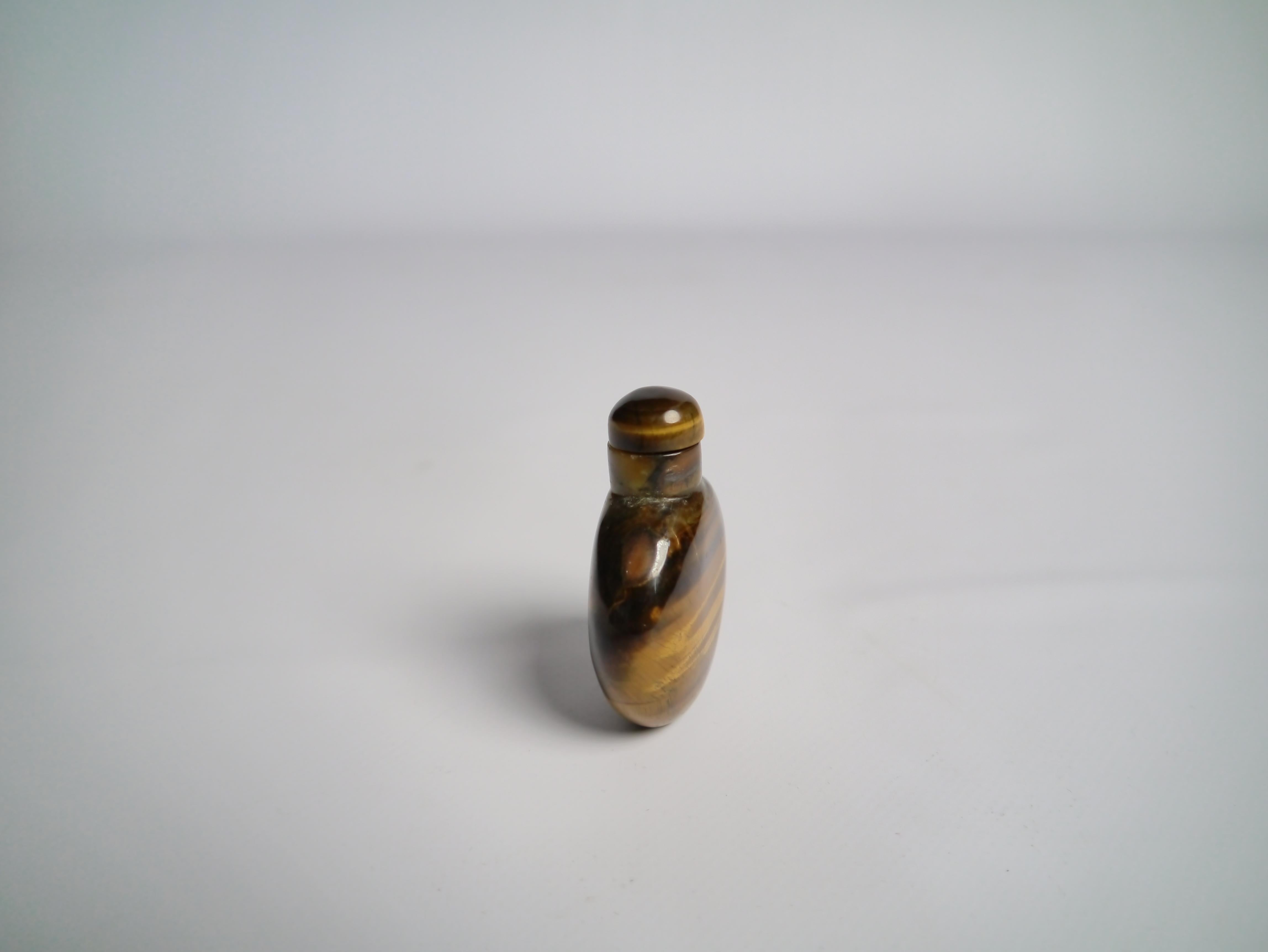 Early 20th century Chinese snuff bottle. Bottle and tap made out of tiger eye stone.