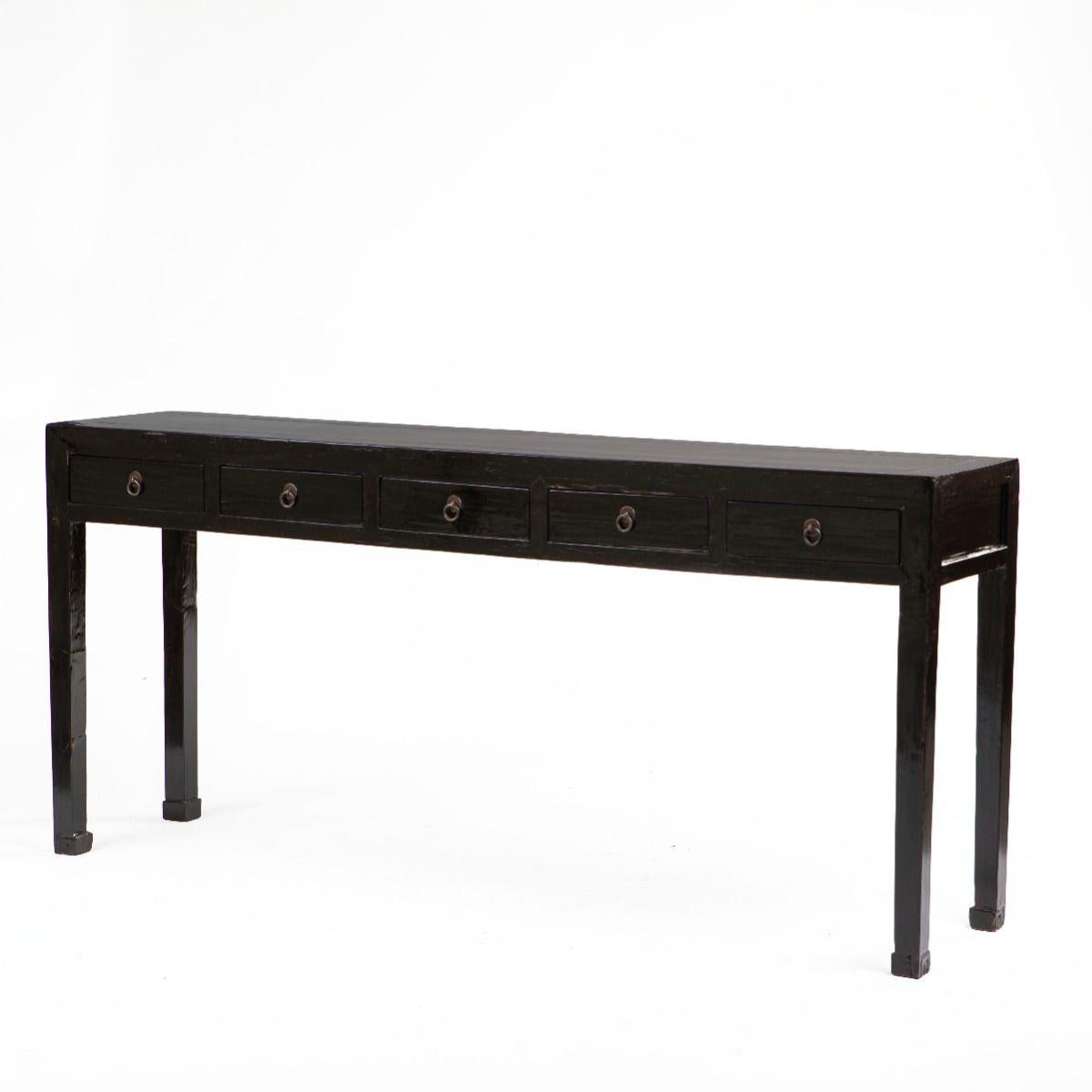 Art Deco console table in black lacquer featuring five drawers with brass ring pulls.
The design is defined by straight, square legs that taper into subtly carved ‘à la grec’ style feet.

Originating from China, circa 1900.