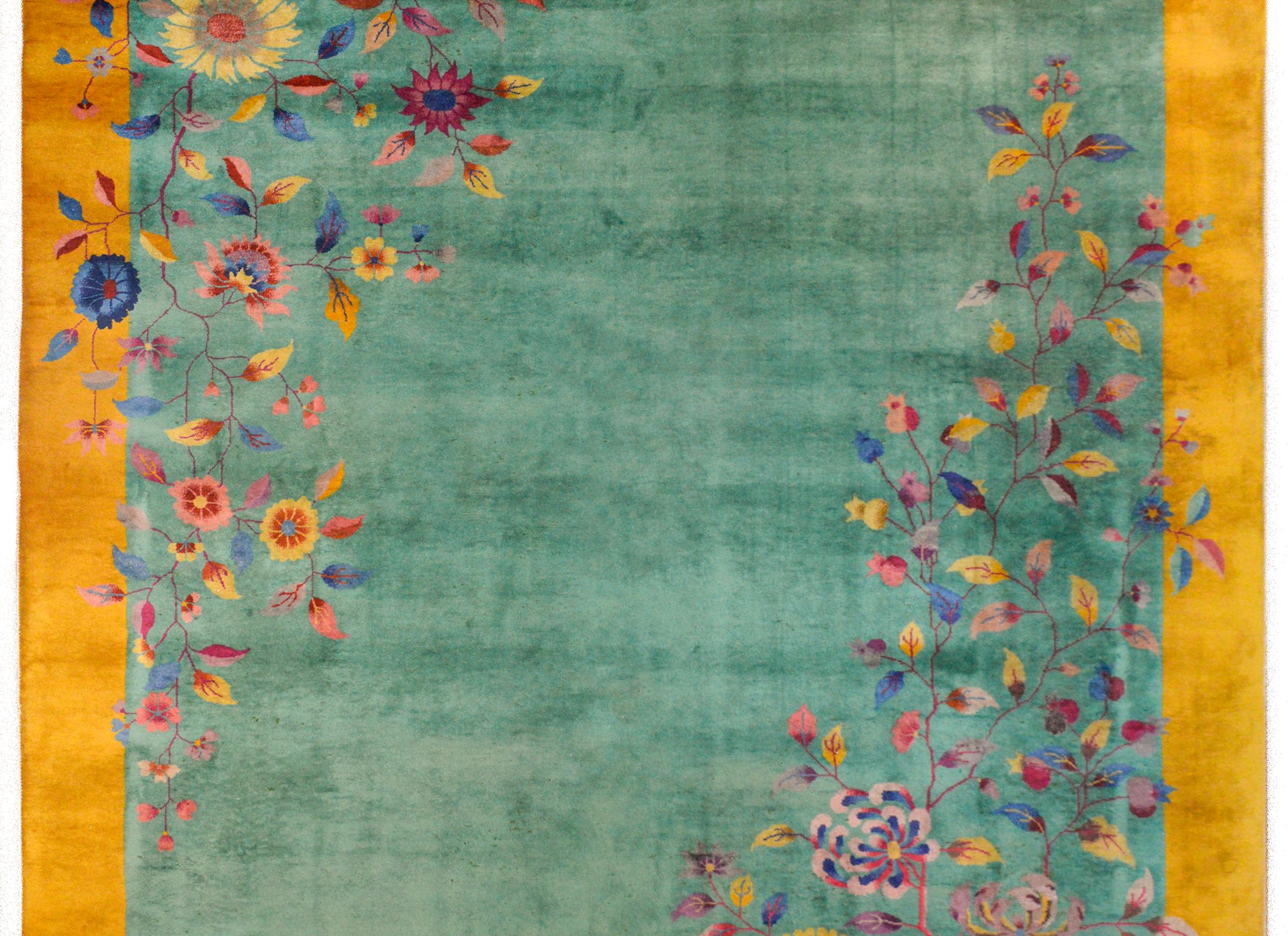 A fantastic early 20th century Chinese Art Deco rug with a mint green field surrounded by a wide goldenrod border. In opposite corners, a wonderful cluster of large peonies and chrysanthemum, and cherry blossoms woven in myriad vivid colors.