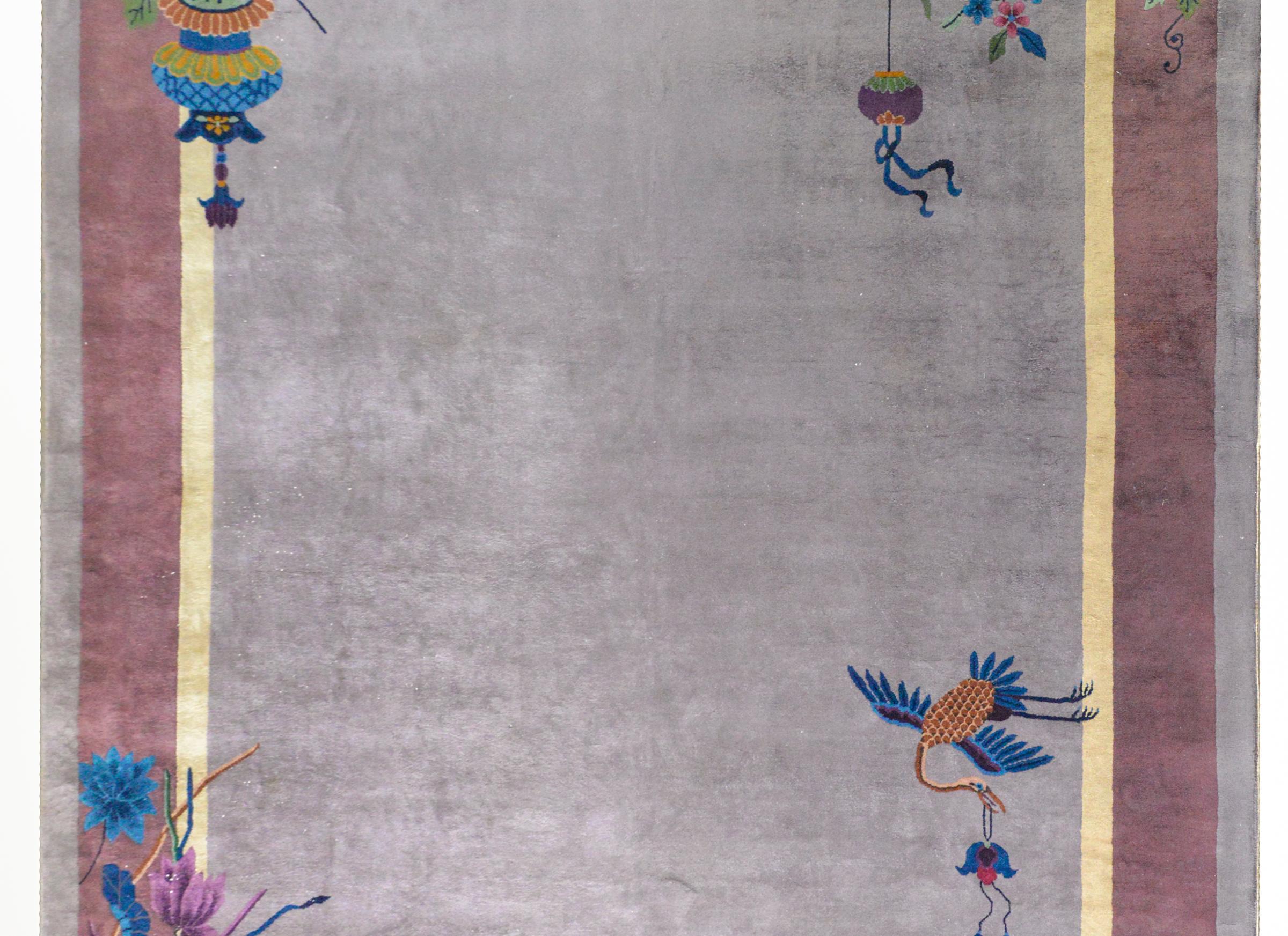 A gorgeous early 20th century Chinese Art Deco rug with a gray field surrounded by a pale yellow, lavender, and gray border overlaid with multi-colored auspicious flowers including peonies, chrysanthemum, lotus, and cherry blossoms, and with a crane