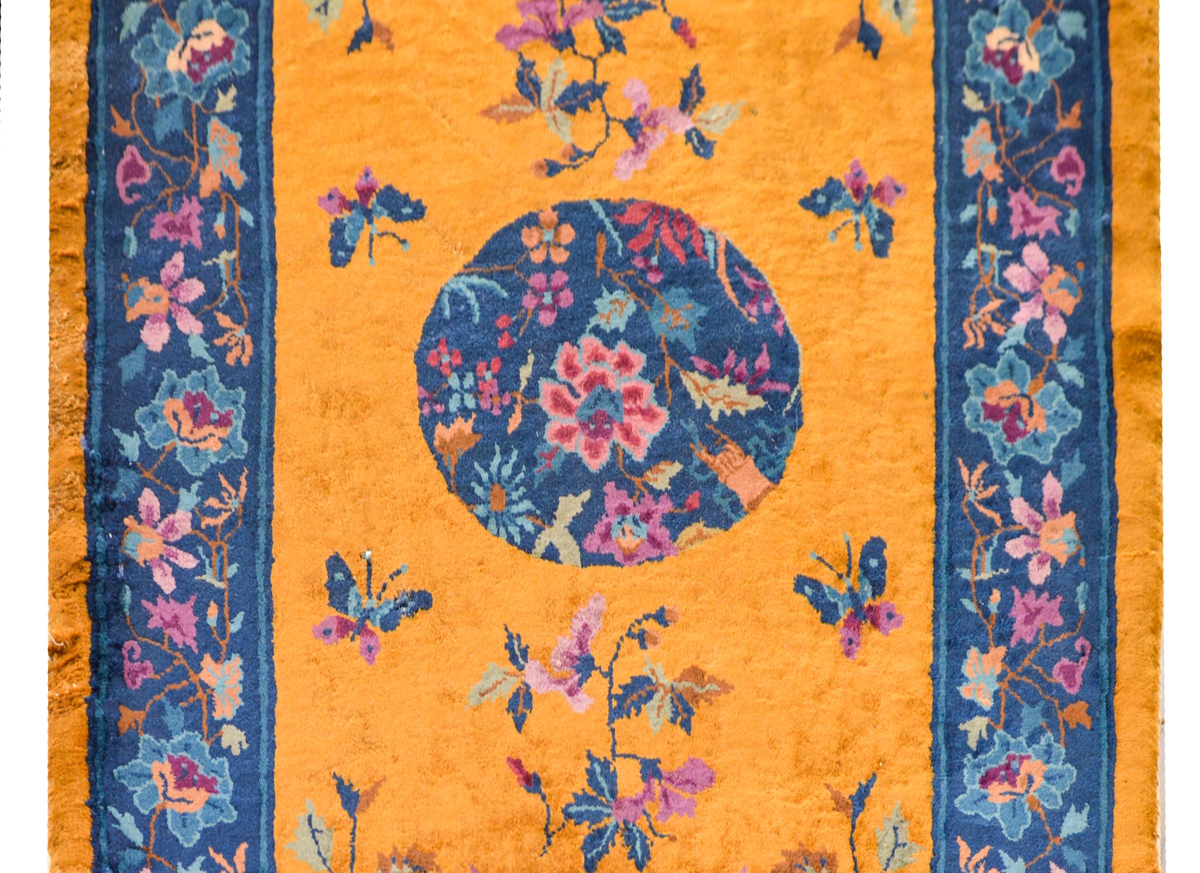 A brilliant and beautiful early 20th century Chinese Art Deco rug with a wonderful central floral medallion containing auspicious flowers including peonies, chrysanthemum, prunus, and citron, and living amidst a field of flowers and butterflies and