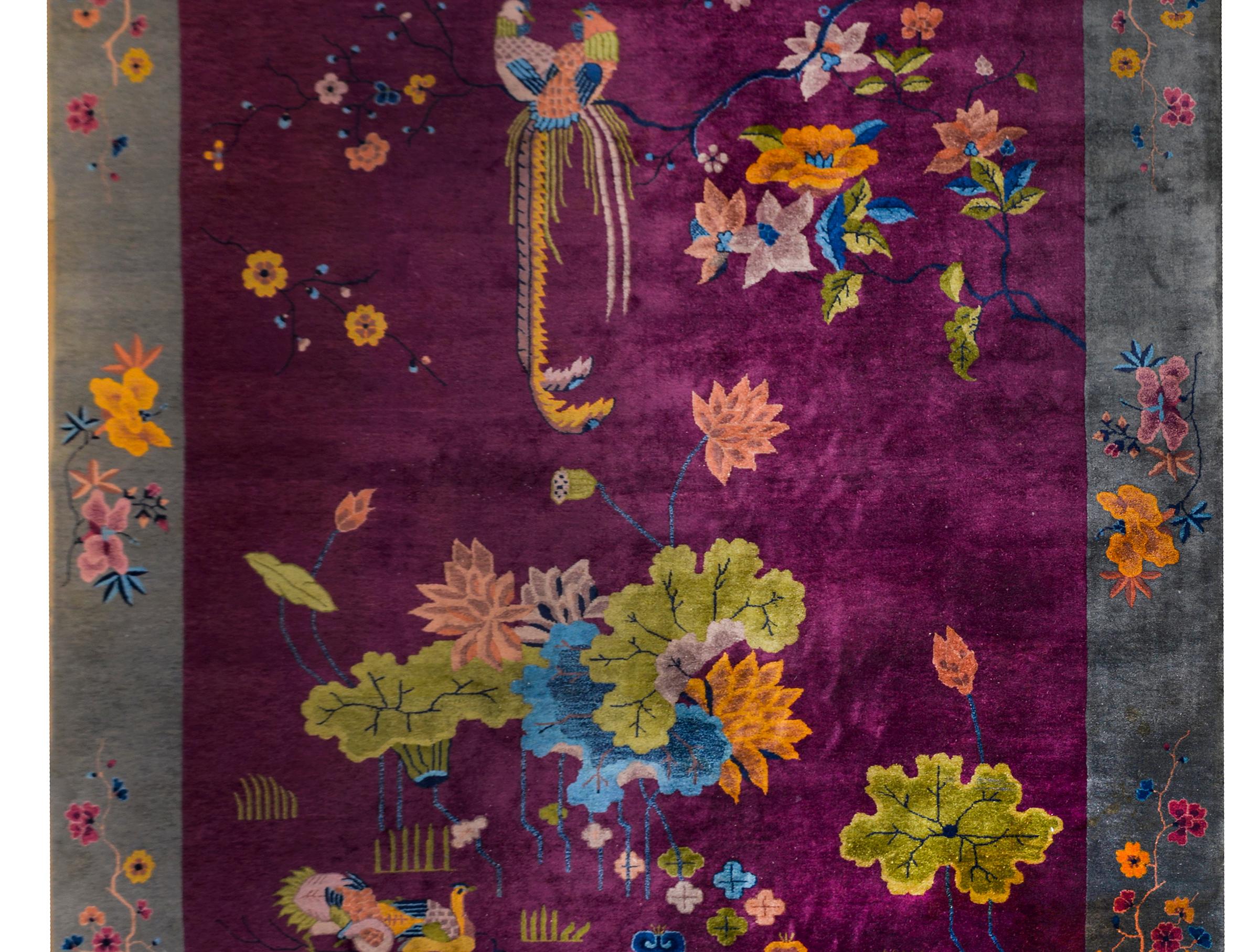 An incredibly gorgeous early 20th century Chines Art Deco rug with the most wonderful rich eggplant field surrounded by a wide dark gray border, and overlaid with large lotus flowers and leaves sprouting form a pond with swimming ducks, and a