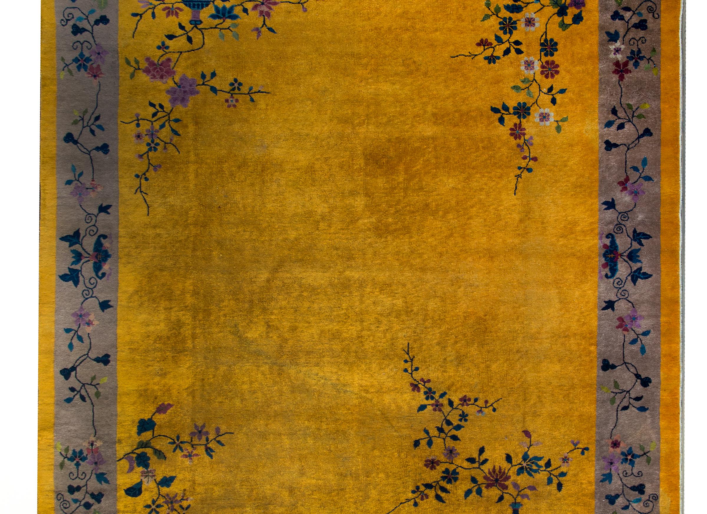 A beautiful early 20th century Chinese Art Deco rug with a deep gold field surrounded by a wide gray stripe border, with vases potted with violet and indigo chrysanthemum and prunus blossoms, and the border with a simple but chic scrolling vine and