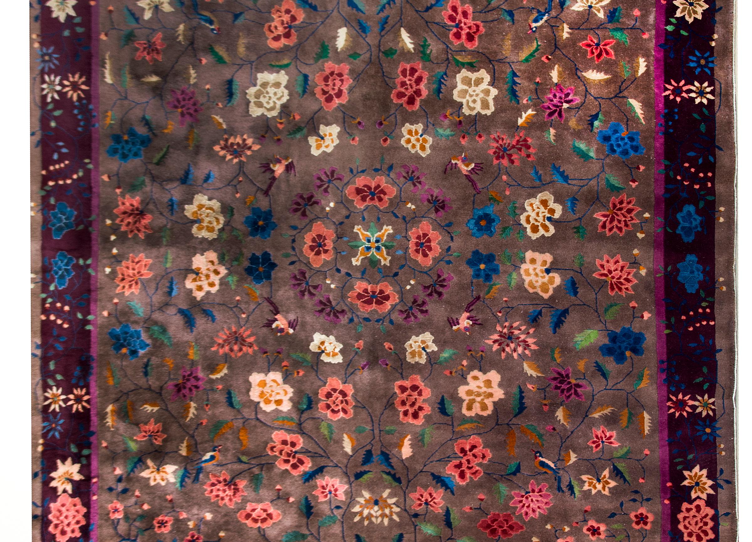 An unbelievable early 20th century Chinese Art Deco rug with a central peony medallion surrounded by even more peonies and chrysanthemum, all woven in a chic color palette of pink, violet, indigo, orange, and yellow, and set against a sophisticated