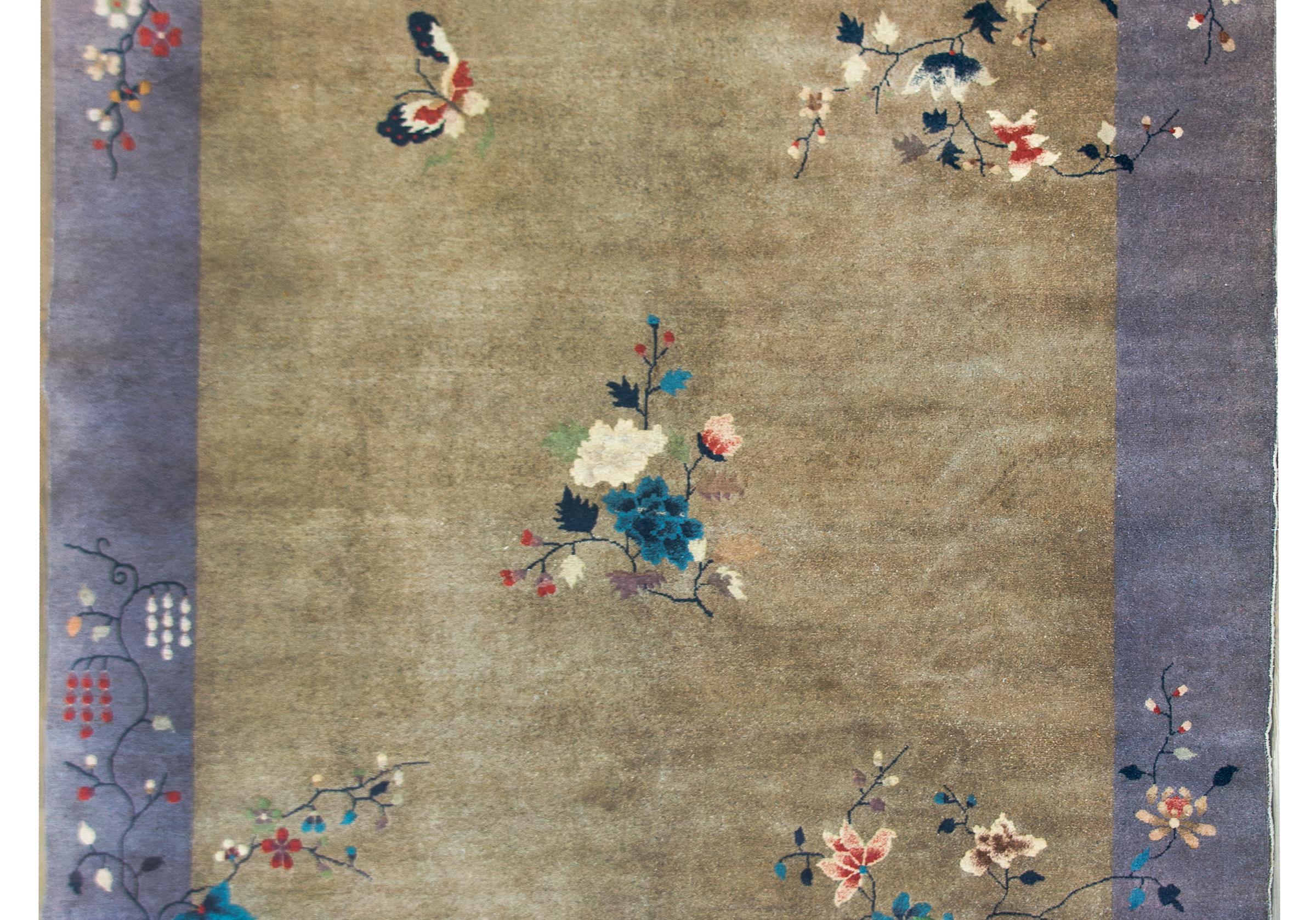 A wonderful early 20th century Chinese Art Deco rug with a chic gray field surround by another gray border, and all overlaid with myriad auspicious flowers including peonies, wisteria, chrysanthemums, and cherry blossoms, all woven in light and dark