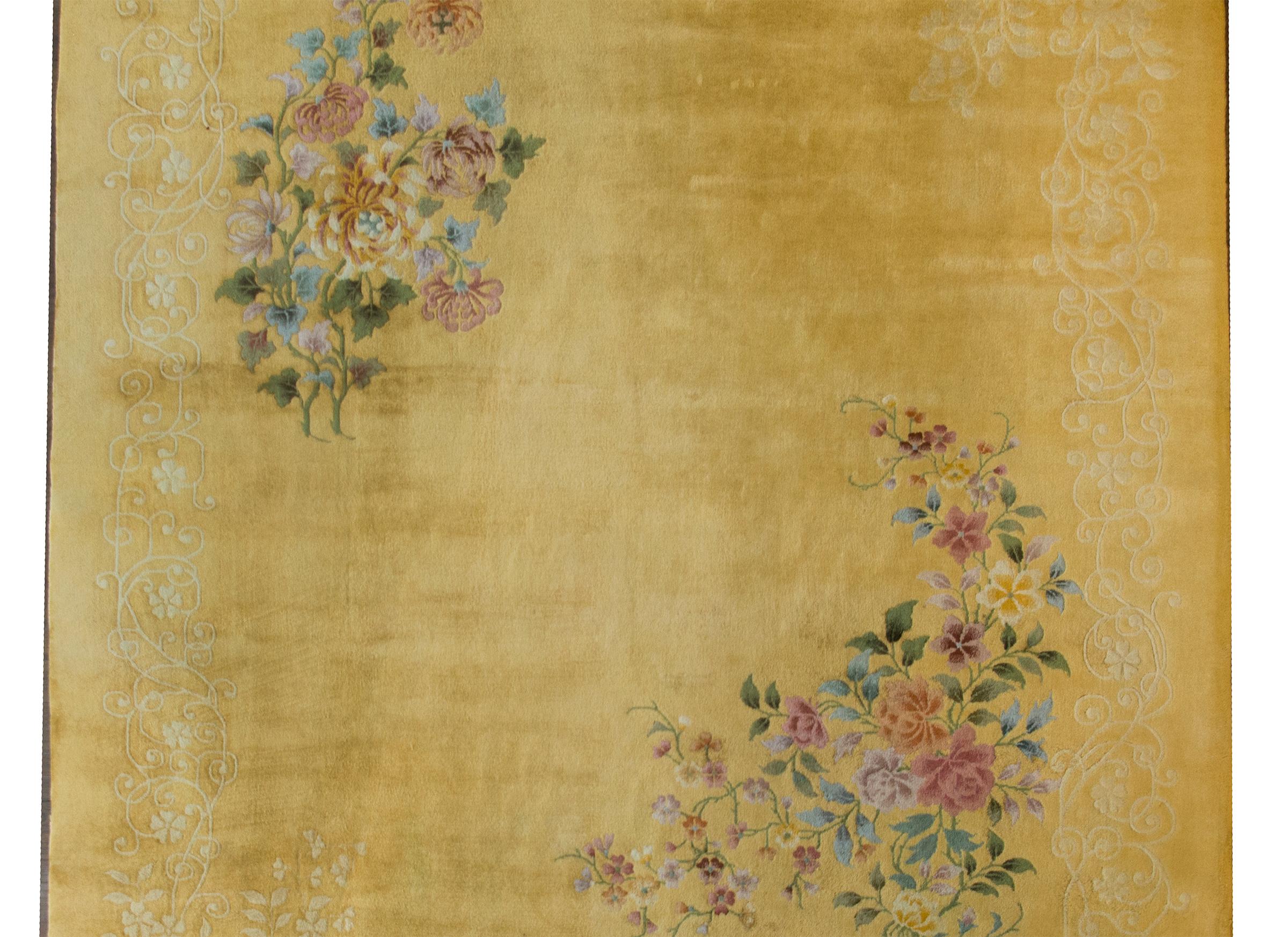 A simple but chic early 20th century Chinese Art Deco rug with two large floral clusters in opposite corners, one with chrysanthemums and the other with peonies, and surrounded by a tone on tone pale yellow floral patterned border against a bold