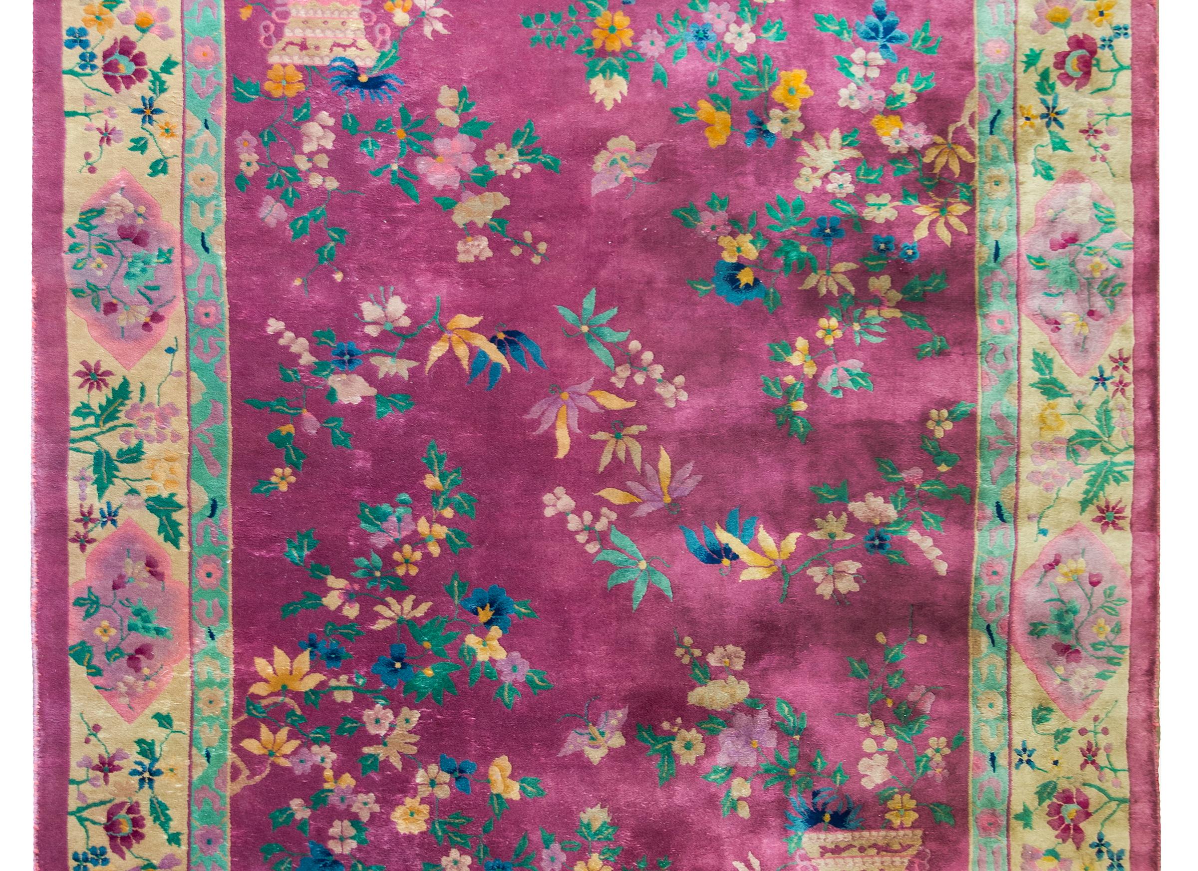 A beautiful early 20th century Chinese Art Deco rug with a mauve central field covered in myriad auspicious flowers including peonies, chrysanthemum, and cherry blossoms, and potted censors in opposite corners, and surrounded by a wide border with