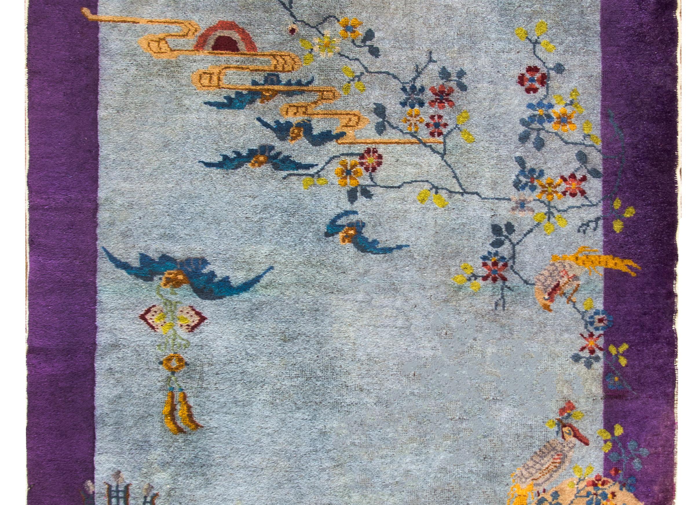A beautiful early 20th century Chinese Art Deco rug with myriad auspicious imagery including five bats, a phoenix, fish, a scholar's vase, and various flowers, all symbols of prosperity, good fortune, and long life.  